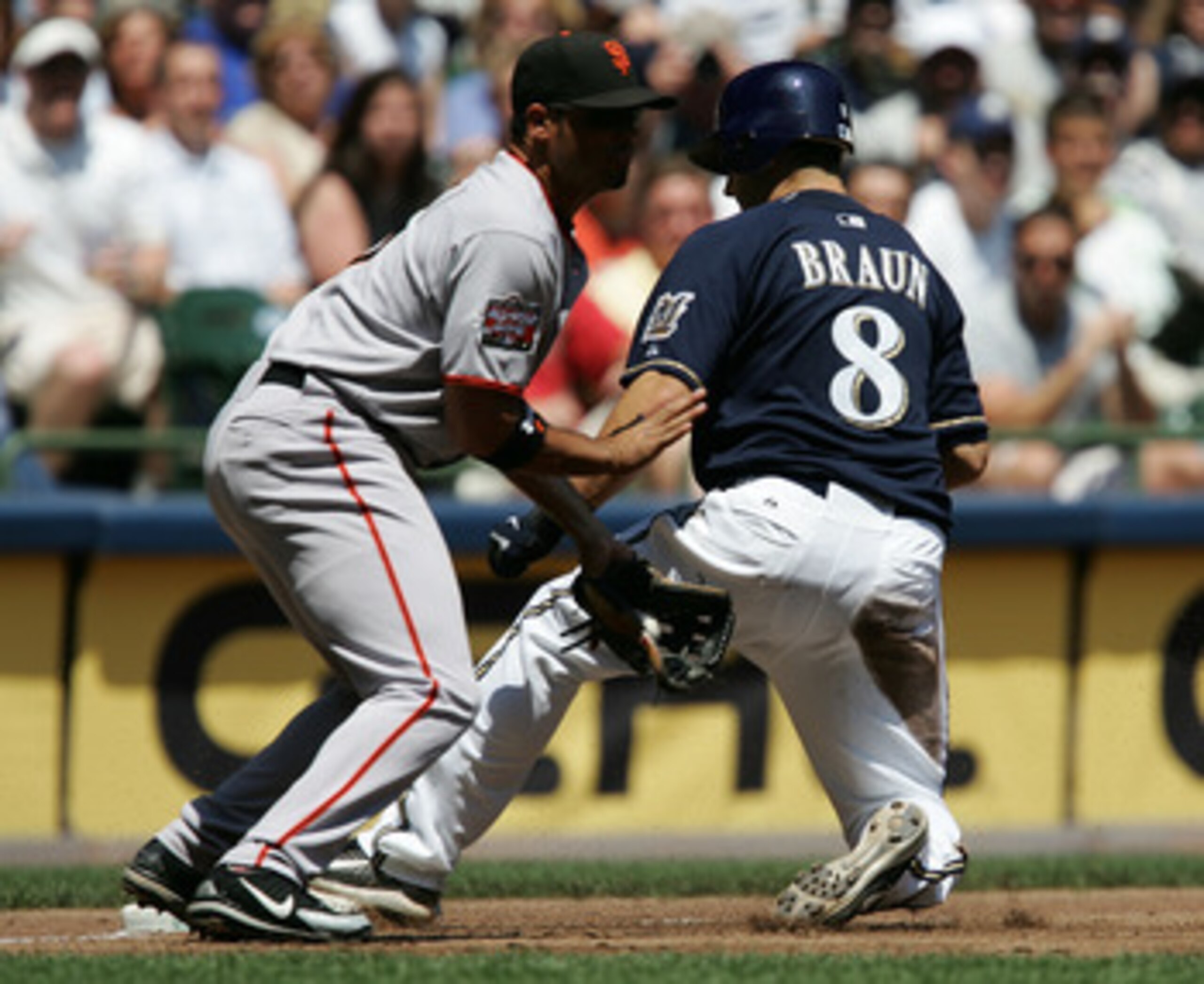 MILWAUKEE - JUNE 20: Ryan Braun #8 of the Milwaukee Brewers beats a throw to Pedro Feliz #7 of the San Francisco Giants at third base for a triple in the 3rd inning on June 20, 2007 at Miller Park in Milwaukee, Wisconsin. The Brewers defeated the Giants 7