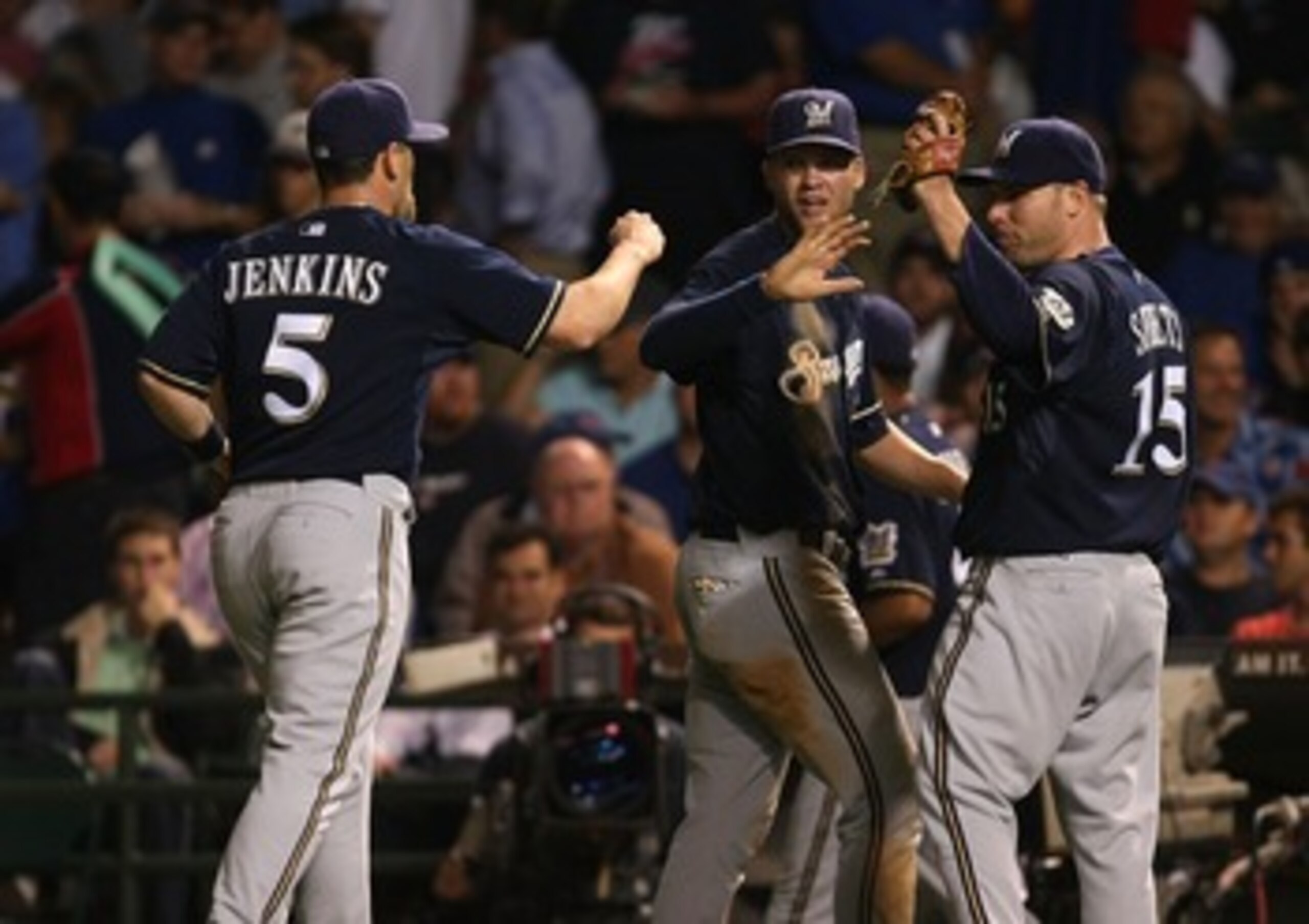 CHICAGO - AUGUST 29:  Geoff Jenkins  #5 of the Milwaukee Brewers is congratulated by teammates Corey Hart #1 and Ben Sheets #15 after making a catch in the outfield in the 4th inning against the Chicago Cubs on August 29, 2007 at Wrigley Field in Chicago,