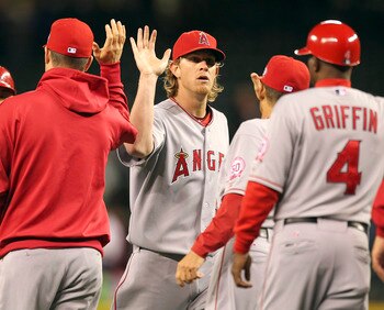SEATTLE - JUNE 14:  Starting pitcher Jered Weaver #36 of the Los Angeles Angels of Anaheim celebrates with teammates after throwing a complete game 4-0 shutout against the Seattle Mariners at Safeco Field on June 14, 2011 in Seattle, Washington. (Photo by