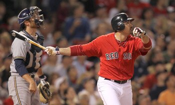 BOSTON, MA  - JUNE 17:  Adrian Gonzalez #28 of the Boston Red Sox connects for a home run as catcher Jonathan Lucroy #20 of the Milwaukee Brewers looks on at Fenway Park on June 17, 2011 in Boston, Massachusetts.  (Photo by Jim Rogash/Getty Images)