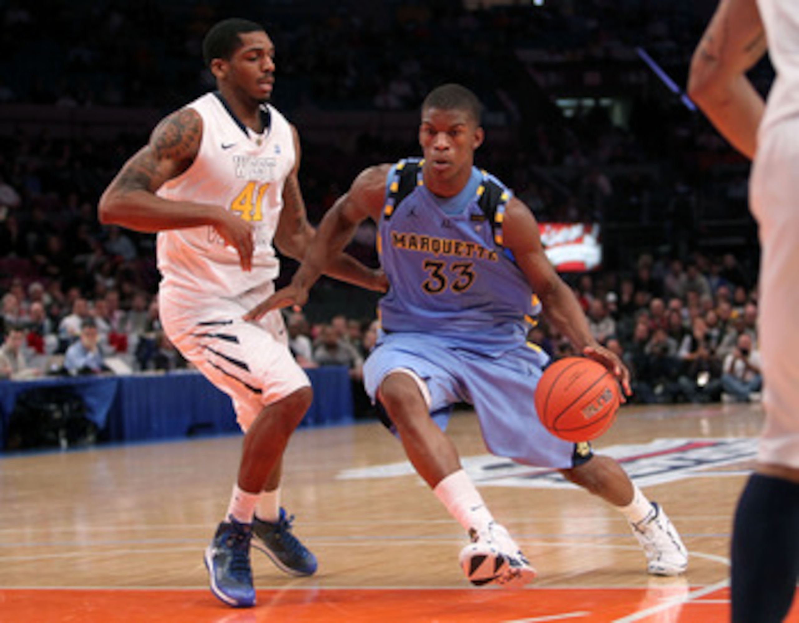 NEW YORK, NY - MARCH 09: Jimmy Butler #33 of the Marquette Golden Eagles drives with the ball against John Flowers #41 of the West Virginia Mountaineers during the second round of the 2011 Big East Men's Basketball Tournament presented by American Eagle O