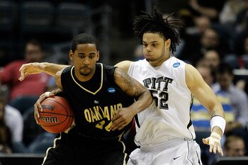 MILWAUKEE - MARCH 19:  Keith Benson #34 of the Oakland Golden Grizzlies posts up Gary McGhee #52 of the Pittsburgh Panthers in the second half during the first round of the 2010 NCAA men's basketball tournament at the Bradley Center on March 19, 2010 in M