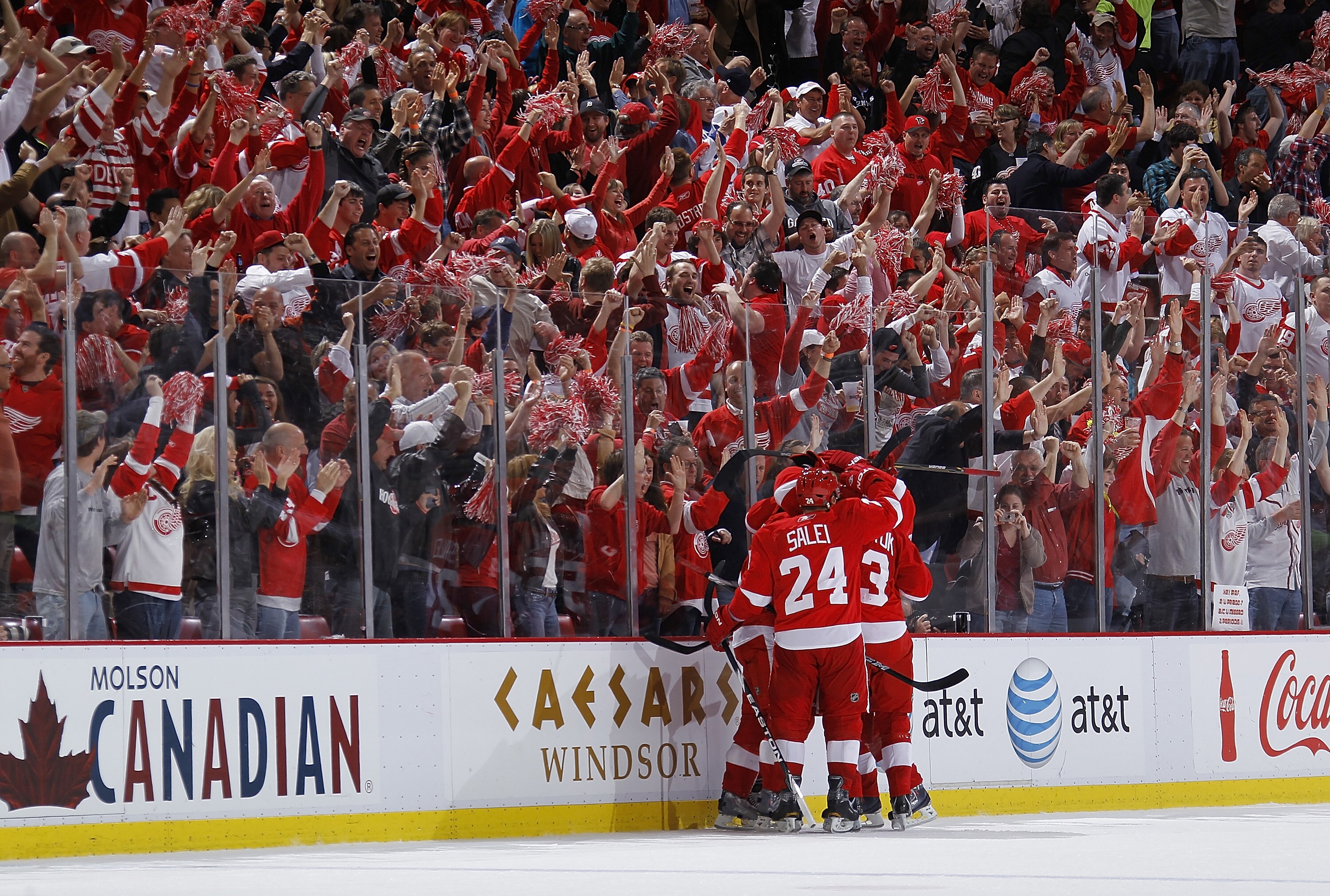 DETROIT - MAY 10:  Ruslan Salei #24 of the Detroit Red Wings celebrates a third period goal by Valtteri Filppula #51 with teammates while playing the San Jose Sharks in Game Six of the Western Conference Semifinals during the 2011 NHL Stanley Cup Playoffs