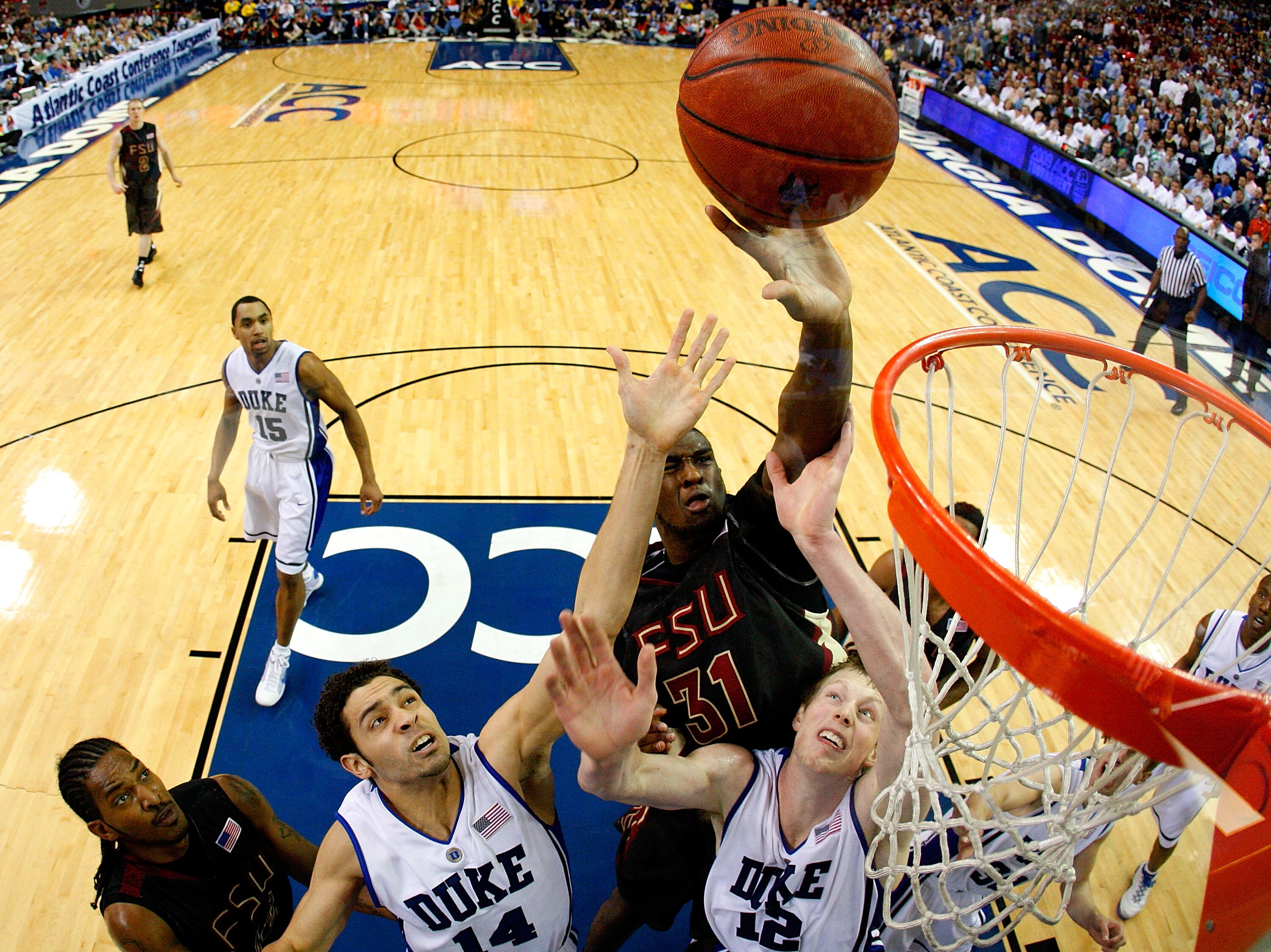 ATLANTA - MARCH 15:  Ryan Reid #42 of the Florida State Seminoles looks on as Chris Singleton #31 tips in a basket against David McClure #14 and Kyle Singler #12 of the Duke Blue Devils during the championship game of the 2009 ACC Men's Basketball Tournam