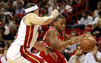 MIAMI, FL - MARCH 27:  Guard Mike Bibby #0 of the Miami Heat defends against gurad Kyle Lowry #7 of the Houston Rockets  at American Airlines Arena on March 27, 2011 in Miami, Florida. NOTE TO USER: User expressly acknowledges and agrees that, by download