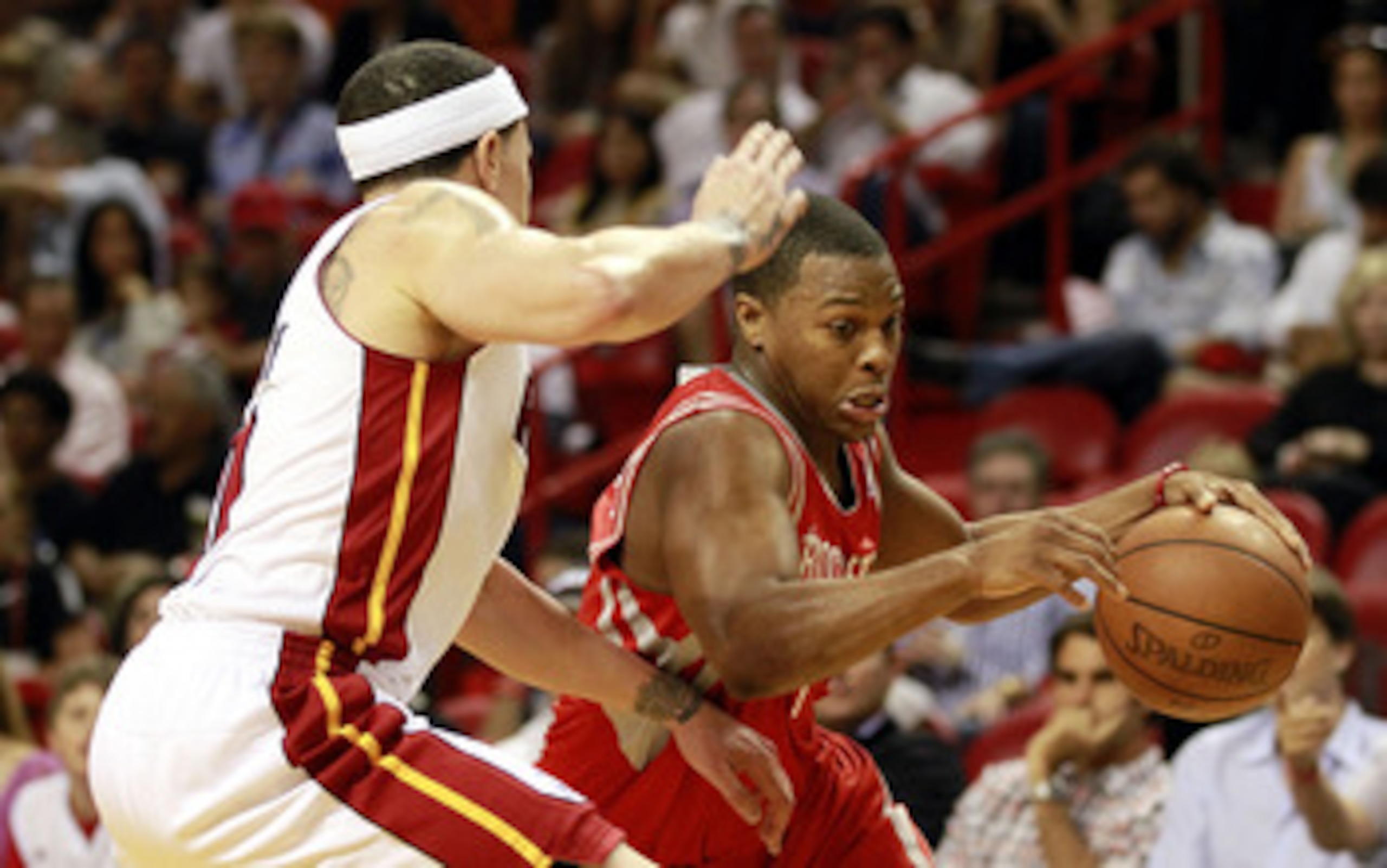 MIAMI, FL - MARCH 27:  Guard Mike Bibby #0 of the Miami Heat defends against gurad Kyle Lowry #7 of the Houston Rockets  at American Airlines Arena on March 27, 2011 in Miami, Florida. NOTE TO USER: User expressly acknowledges and agrees that, by download