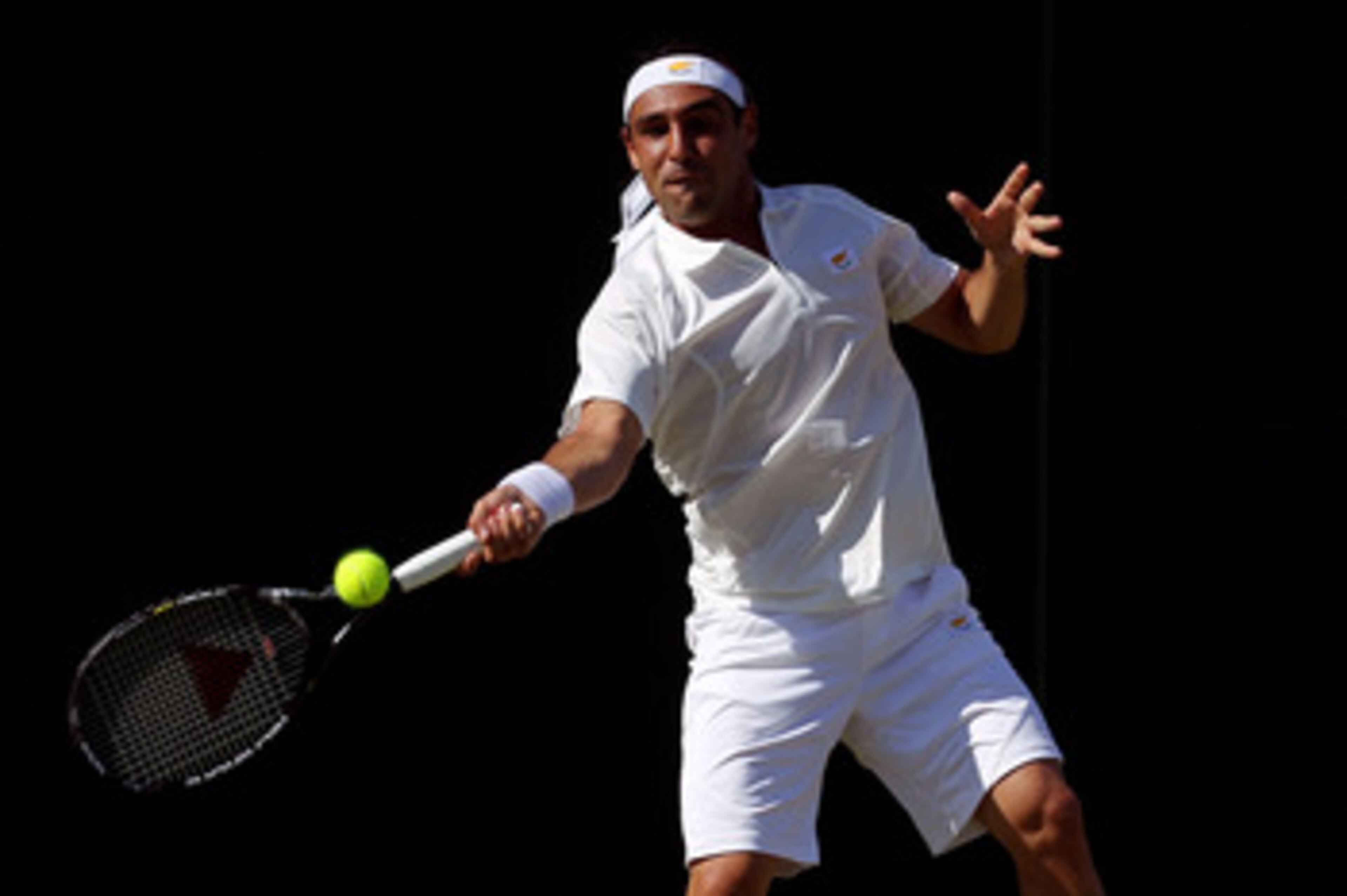 LONDON, ENGLAND - JUNE 22:  Marcos Baghdatis of Cyprus in action during the first round match against Lukas Lacko of Slovakia on Day Two of the Wimbledon Lawn Tennis Championships at the All England Lawn Tennis and Croquet Club on June 22, 2010 in London,