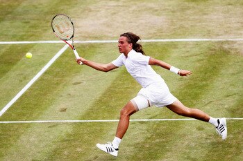 LONDON, ENGLAND - JUNE 24:  Alexandr Dolgopolov of Ukraine in action during his second round match against Jo-Wilfried Tsonga of France on Day Four of the Wimbledon Lawn Tennis Championships at the All England Lawn Tennis and Croquet Club on June 24, 2010