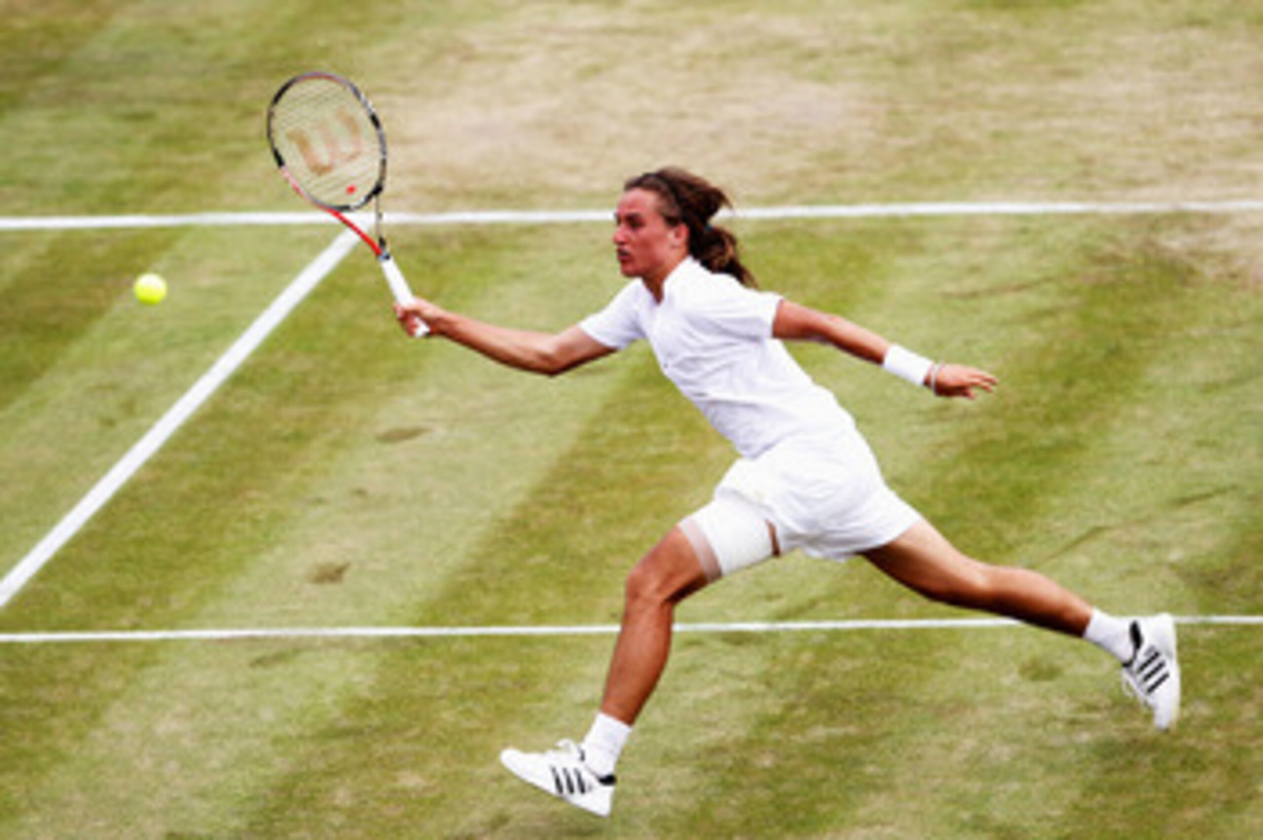 LONDON, ENGLAND - JUNE 24:  Alexandr Dolgopolov of Ukraine in action during his second round match against Jo-Wilfried Tsonga of France on Day Four of the Wimbledon Lawn Tennis Championships at the All England Lawn Tennis and Croquet Club on June 24, 2010