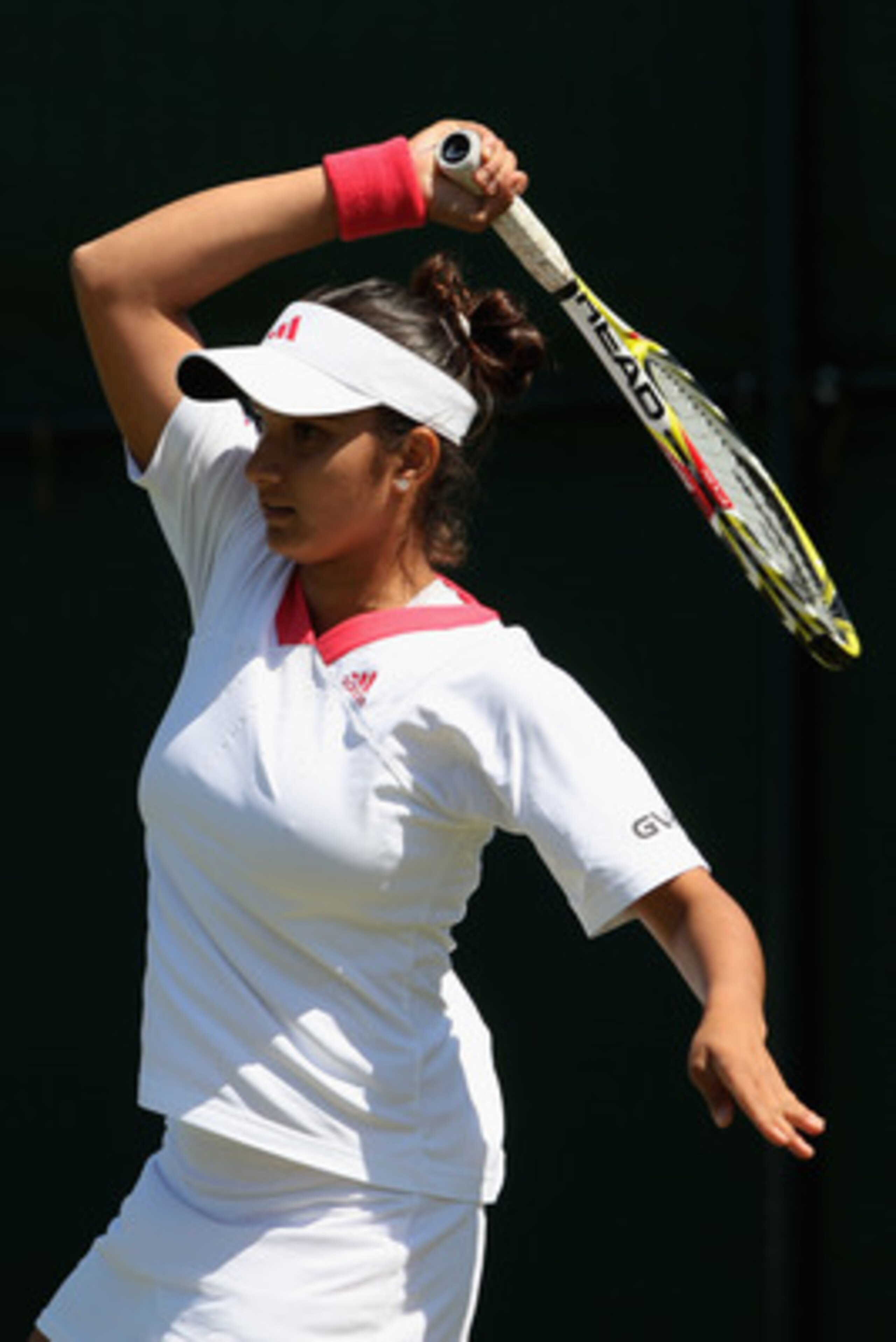 WIMBLEDON, ENGLAND - JUNE 24:  Sania Mirza of India plays a forehand during the women's singles second round match against Sorana Cirstea of Romania on Day Three of the Wimbledon Lawn Tennis Championships at the All England Lawn Tennis and Croquet Club on
