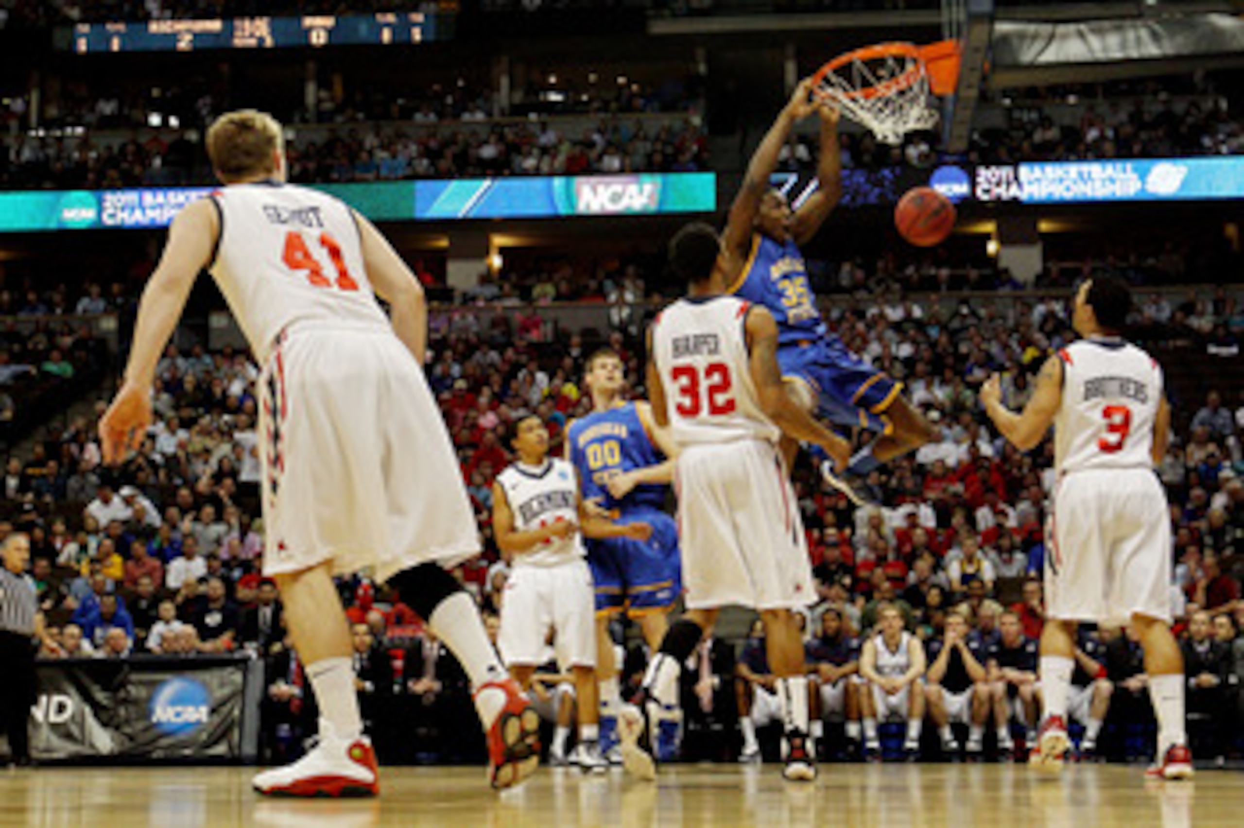 DENVER, CO - MARCH 19:  Kenneth Faried #35 of the Morehead State Eagles dunks the ball against Justin Harper #32 and Darien Brothers #3 of the Richmond Spiders during the third round of the 2011 NCAA men's basketball tournament at Pepsi Center on March 19