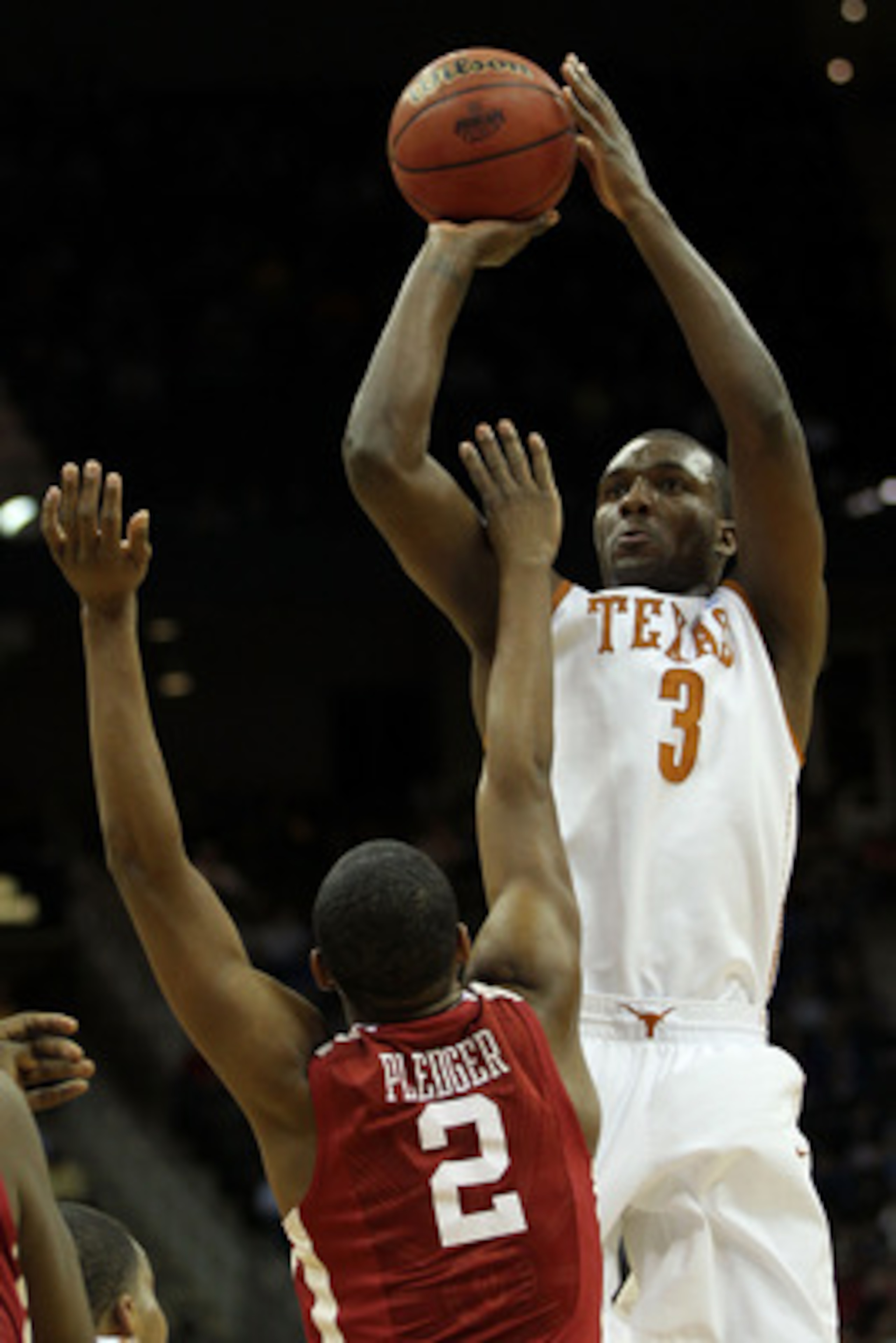 KANSAS CITY, MO - MARCH 10:  Jordan Hamilton #3 of the Texas Longhorns takes a shot over Steven Pledger #2 of the Oklahoma Sooners during their quarterfinal game in the 2011 Phillips 66 Big 12 Men's Basketball Tournament at Sprint Center on March 10, 2011