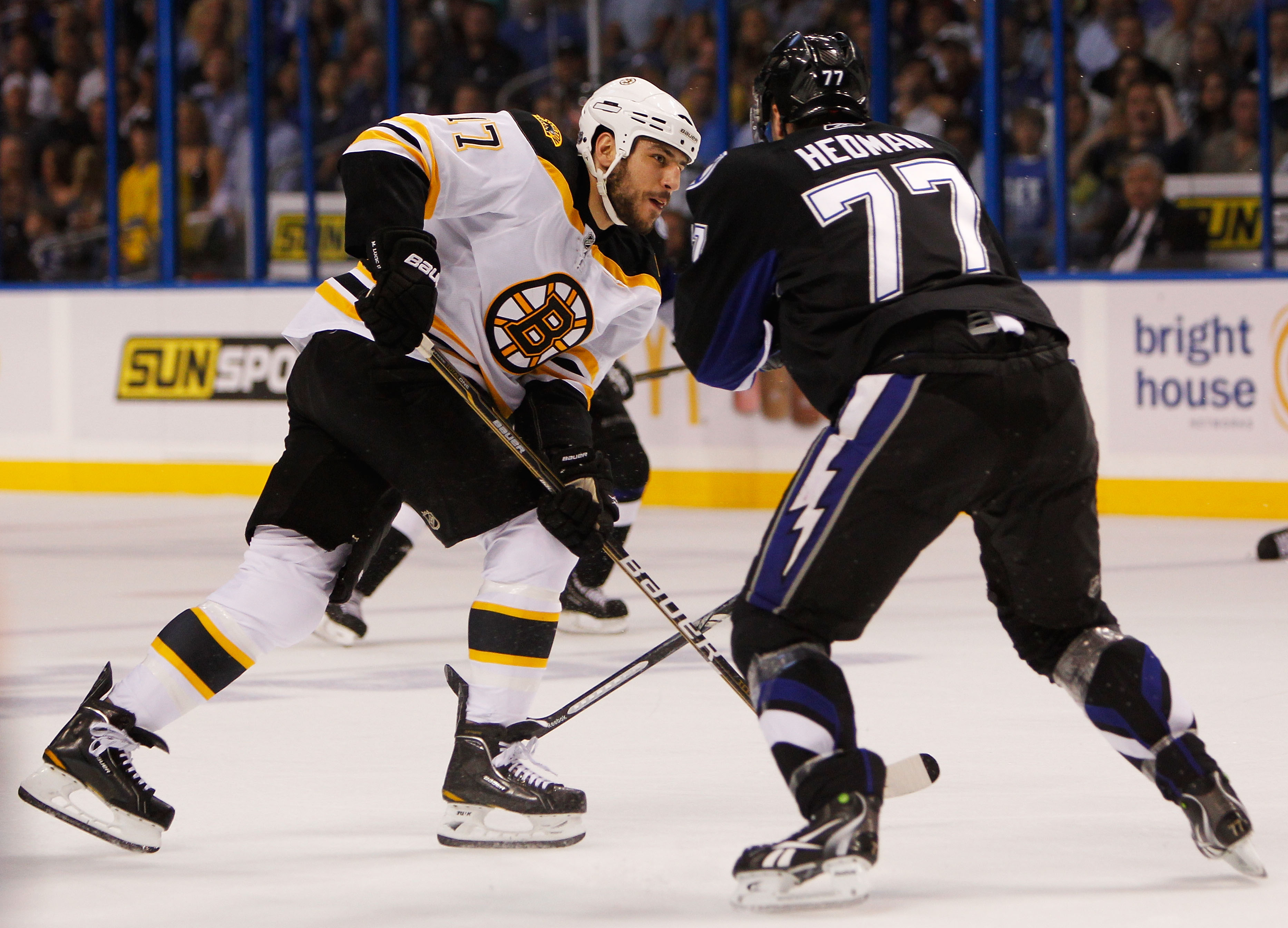 TAMPA, FL - MAY 25:  Milan Lucic #17 of the Boston Bruins shoots his first period goal through the legs of Victor Hedman #77 of the Tampa Bay Lightning in Game Six of the Eastern Conference Finals during the 2011 NHL Stanley Cup Playoffs at St Pete Times