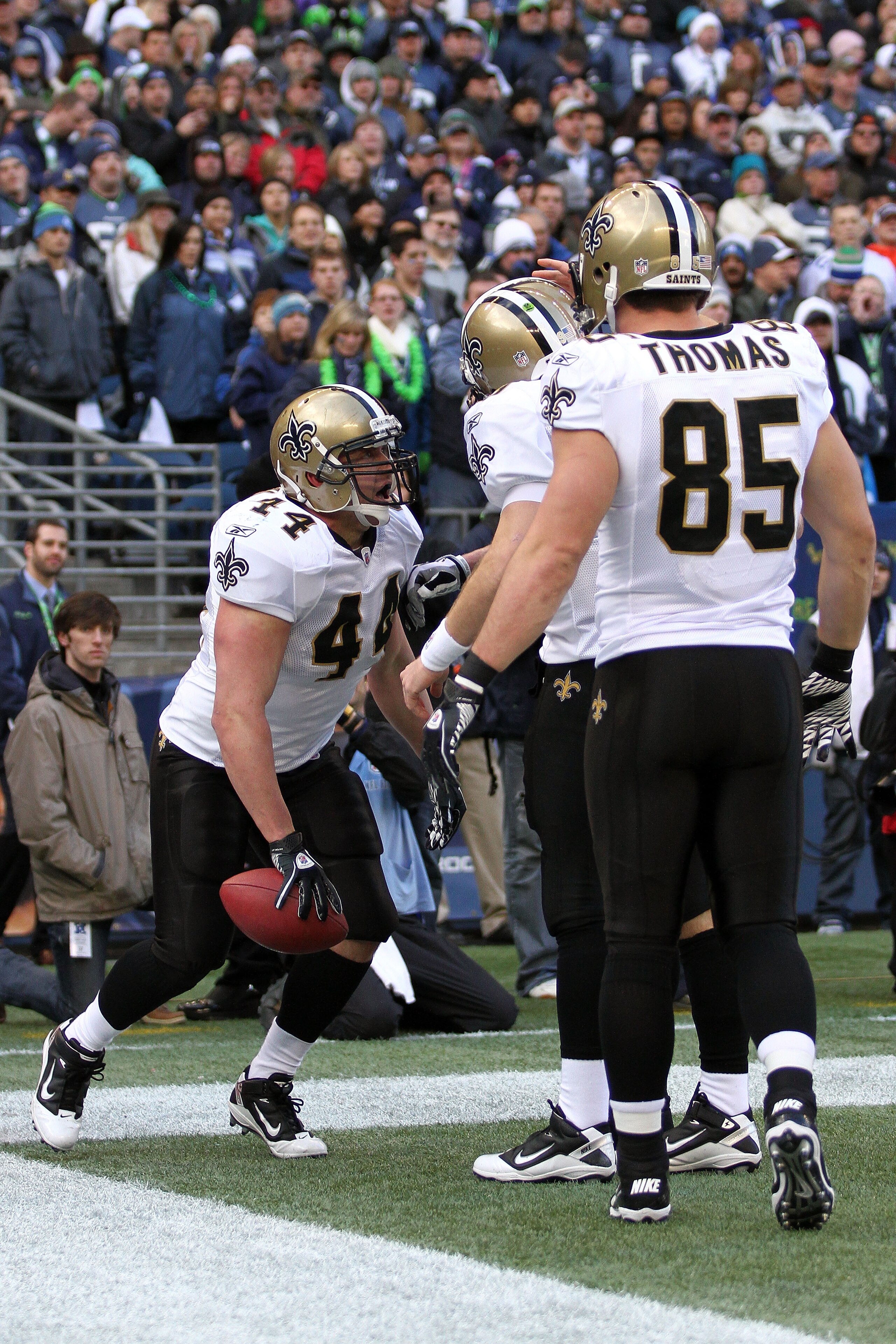 SEATTLE, WA - JANUARY 08:  Heath Evans #44 of the New Orleans Saints celebrates his one-yard touchdown reception with teammates Drew Brees #9 and David Thomas #85 in the first quarter against the Seattle Seahawks during the 2011 NFC wild-card playoff game