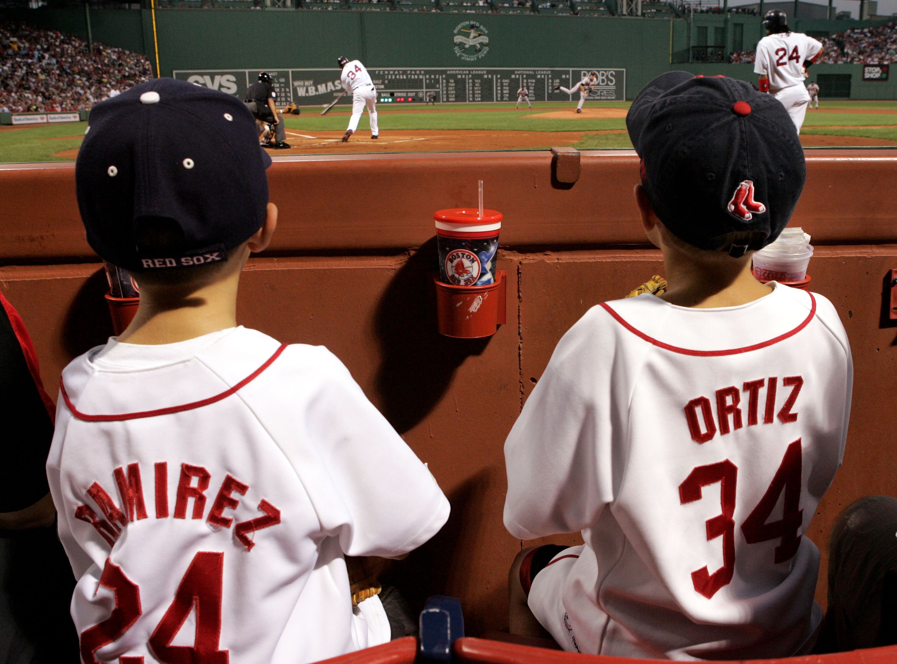 BOSTON - SEPTEMBER 2:  Young fans of the Boston Red Sox watch as David Ortiz #34 bats and Manny Ramirez #24 waits on deck during the first inning against the Baltimore Orioles at Fenway Park on September 2, 2005 in Boston, Massachusetts.  (Photo by Jim Mc