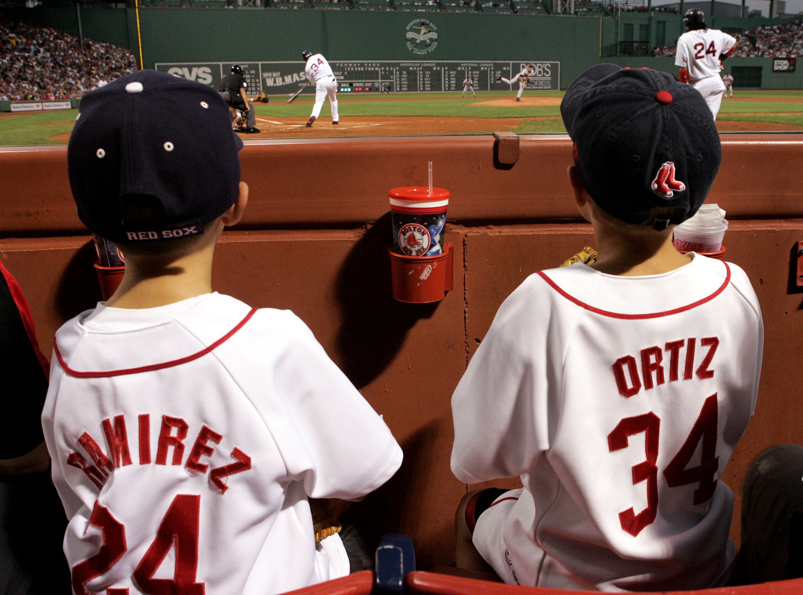 BOSTON - SEPTEMBER 2: Young fans of the Boston Red Sox watch as David Ortiz #34 bats and Manny Ramirez #24 waits on deck during the first inning against the Baltimore Orioles at Fenway Park on September 2, 2005 in Boston, Massachusetts. (Photo by Jim Mc BOSTON - SEPTEMBER 2: Young fans of the Boston Red Sox watch as David Ortiz #34 bats and Manny Ramirez #24 waits on deck during the first inning against the Baltimore Orioles at Fenway Park on September 2, 2005 in Boston, Massachusetts. (Photo by Jim Mc