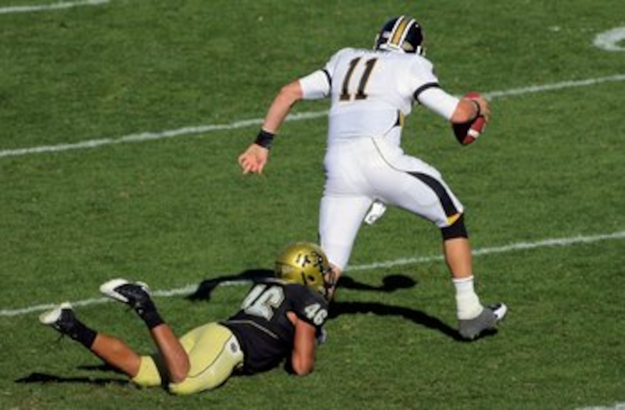 BOULDER, CO - OCTOBER 31: Quarterback Blaine Gabbert #11 of the Missouri Tigers scrambles and tries to break the tackle of Anthony Perkins #46 of the Colorado Buffaloes at Folsom Field on October 31, 2009 in Boulder, Colorado. Missouri defeated Colorado BOULDER, CO - OCTOBER 31: Quarterback Blaine Gabbert #11 of the Missouri Tigers scrambles and tries to break the tackle of Anthony Perkins #46 of the Colorado Buffaloes at Folsom Field on October 31, 2009 in Boulder, Colorado. Missouri defeated Colorado