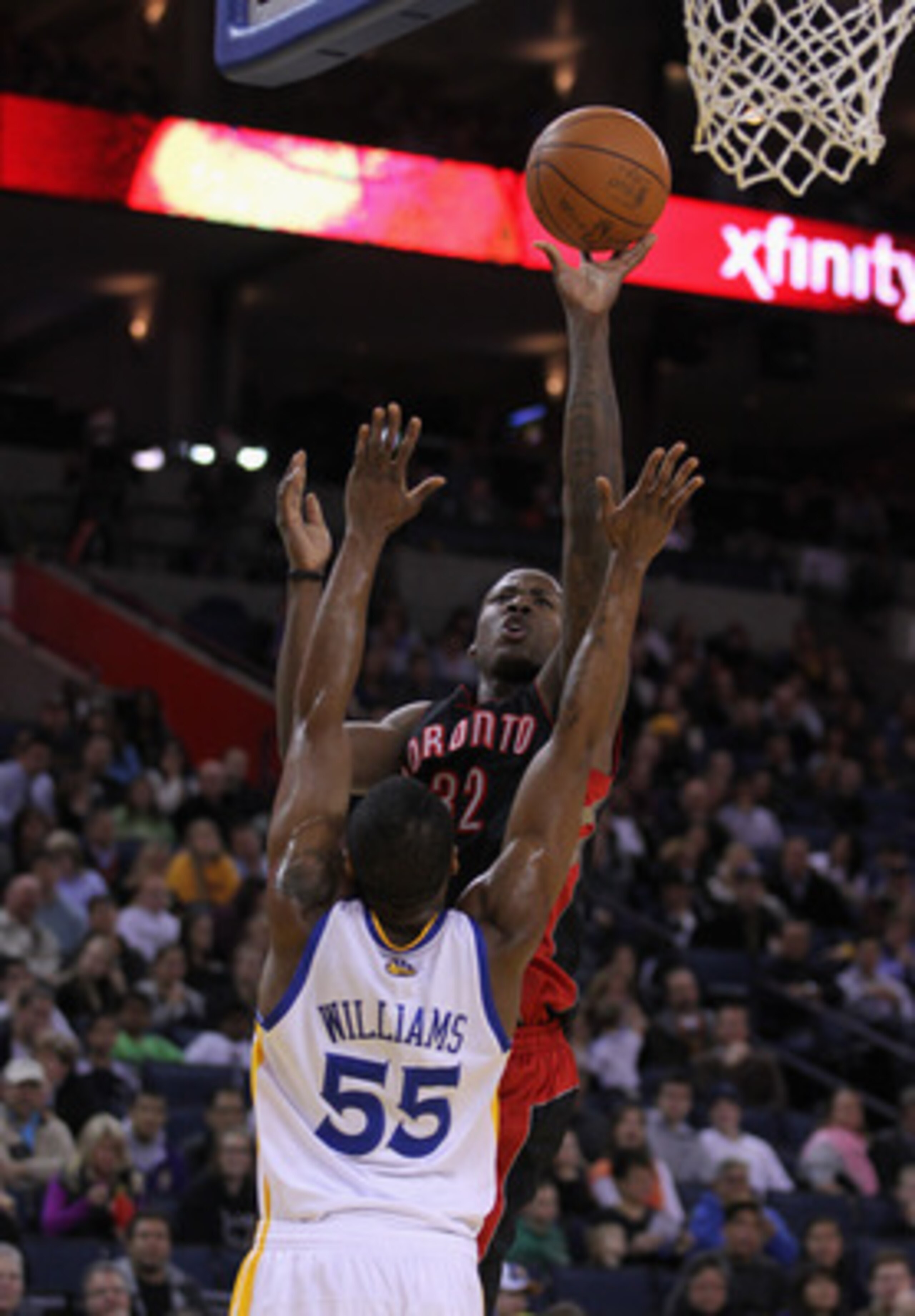 OAKLAND, CA - MARCH 25: Ed Davis #32 of the Toronto Raptors shoots over Reggie Williams #55 of the Golden State Warriors at Oracle Arena on March 25, 2011 in Oakland, California. NOTE TO USER: User expressly acknowledges and agrees that, by downloading an