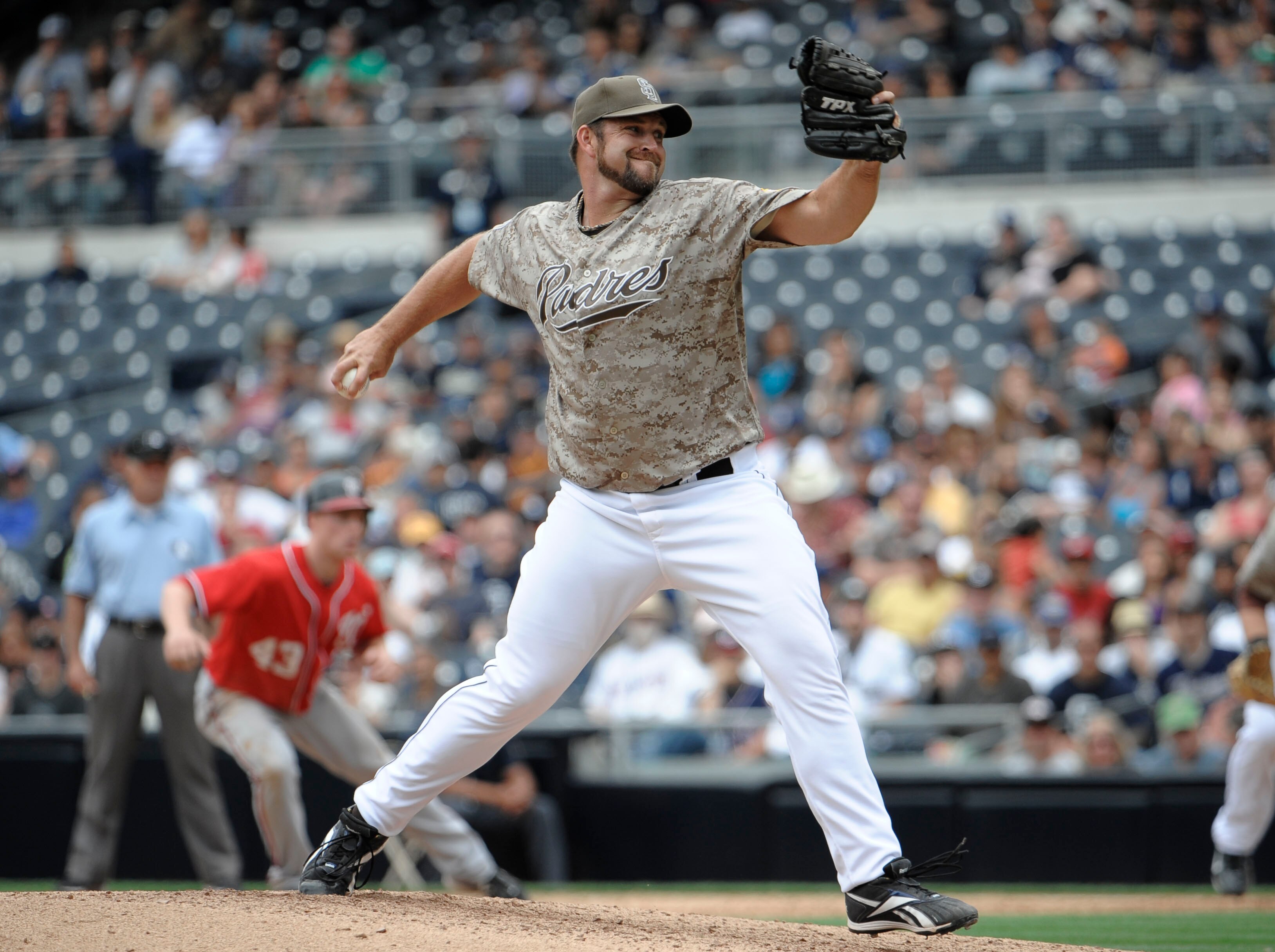 SAN DIEGO, CA - JUNE 12: Heath Bell #21 of the San Diego Padres pitches during the ninth inning of a baseball game against the Washington Nationals at Petco Park on June 12, 2011 in San Diego, California.  The Nationals won 2-0.  (Photo by Denis Poroy/Get