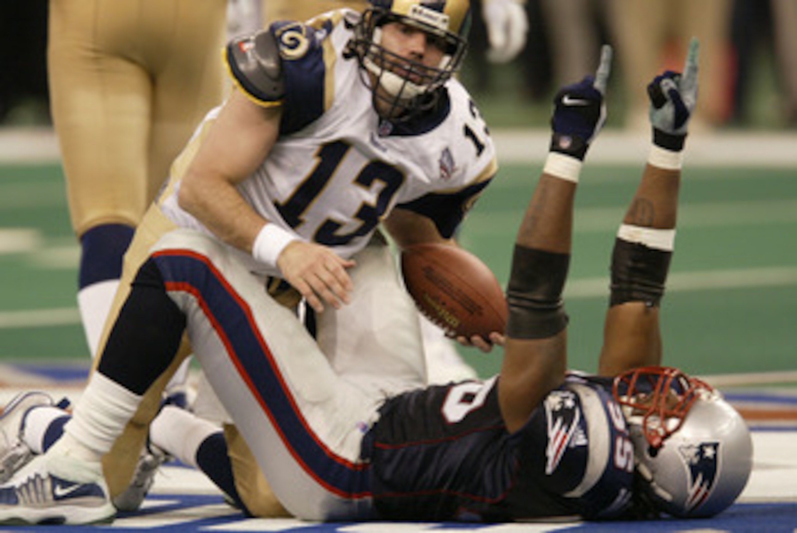 3 Feb 2002:   Defensive end Willie McGinest #55 of the New England Patriots celebrates after sacking quarterback Kurt Warner #13 of the St. Louis Rams during the second half of Super Bowl XXXVI between the New England Patriots and the St. Louis Rams at th