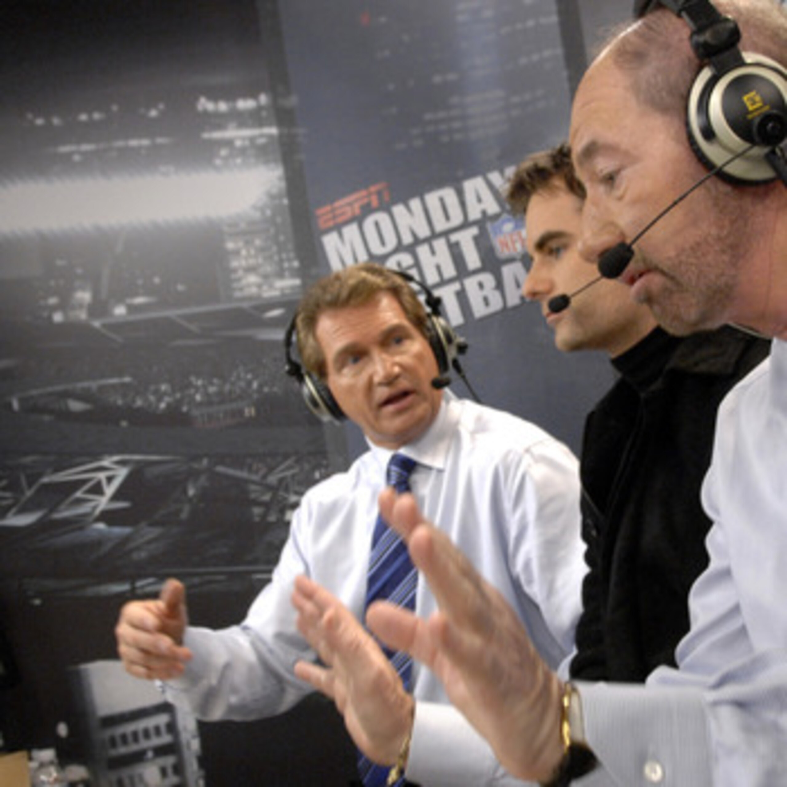 ESPN 's Joe Theismann and Tony Kornheisher talks with NASCAR driver Jeff Gordon on Monday Night Football Nov. 13, 2006 as the Carolina Panthers host the Tampa Bay Buccaneers  in Charlotte.  The Panthers won 24 - 10.  (Photo by Al Messerschmidt/Getty Image
