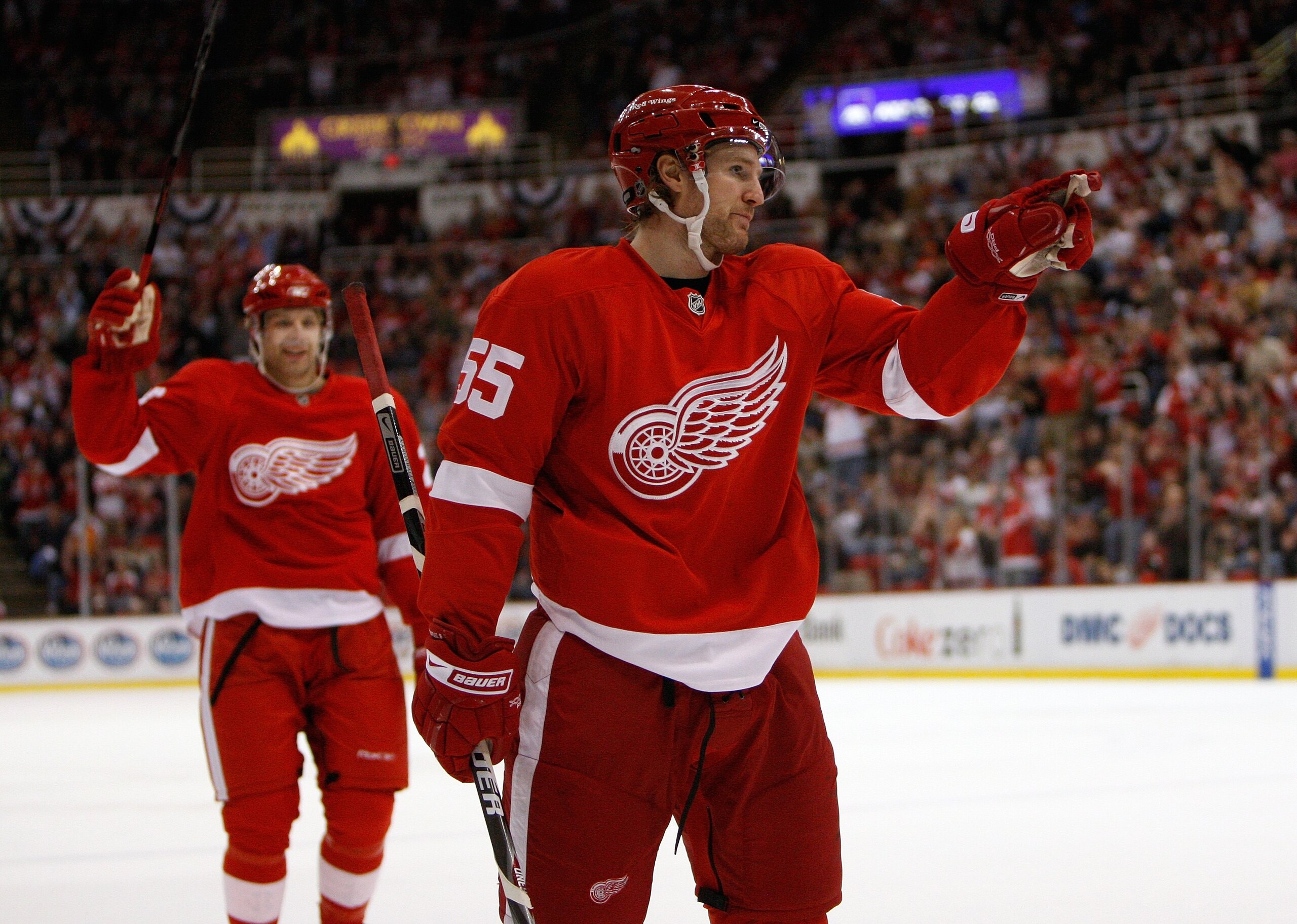 DETROIT - MARCH 15:  Brad Stuart #23 of the Detroit Red Wings raises his stick to celebrate as Niklas Kronwall #55 points toward a teammate after a goal against the Nashville Predators during NHL game action on March 15, 2008 at Joe Louis Arena in Detroit