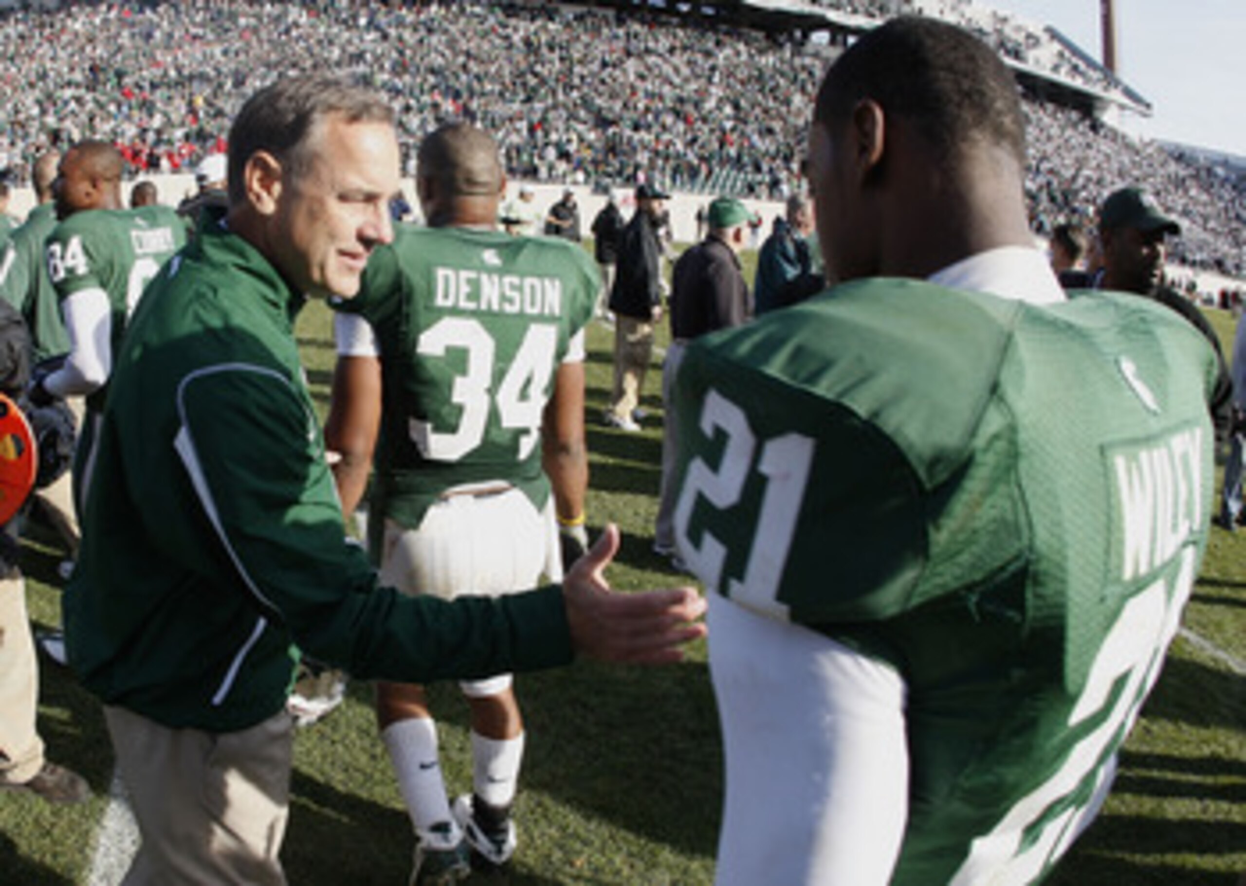 EAST LANSING, MI - NOVEMBER 01: Head coach Mike Dantonio of the Michigan State Spartans congratulates Otis Wiley #21 after beating the Wisconsin Badgers 25-24 on November 1, 2008 at Spartan Stadium in East Lansing, Michigan. (Photo by Gregory Shamus/Get EAST LANSING, MI - NOVEMBER 01: Head coach Mike Dantonio of the Michigan State Spartans congratulates Otis Wiley #21 after beating the Wisconsin Badgers 25-24 on November 1, 2008 at Spartan Stadium in East Lansing, Michigan. (Photo by Gregory Shamus/Get