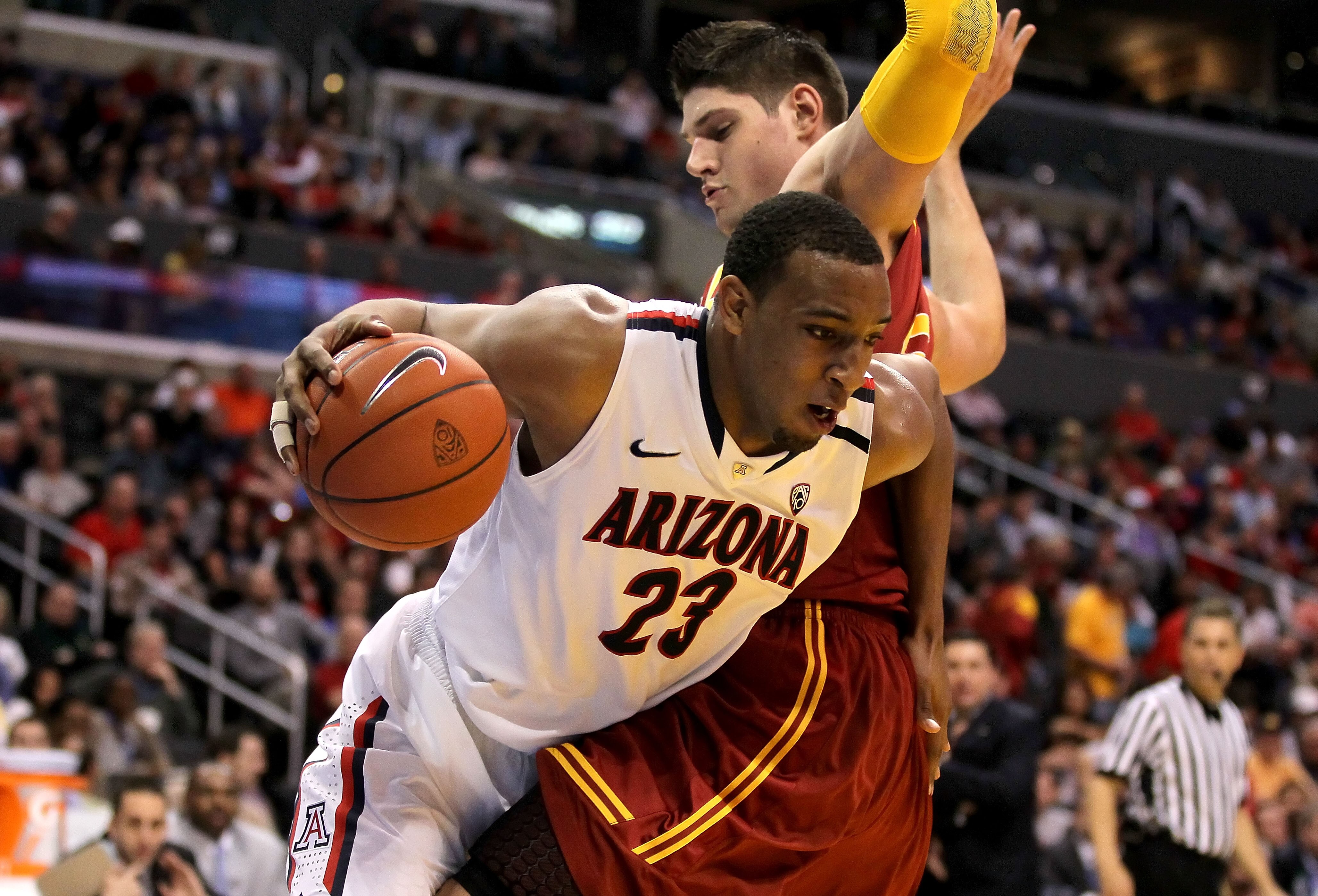 LOS ANGELES, CA - MARCH 11:  Derrick Williams #23 of the Arizona Wildcats drives on Nikola Vucevic #5 of the USC Trojans in the first half in the semifinals of the 2011 Pacific Life Pac-10 Men's Basketball Tournament at Staples Center on March 11, 2011 in
