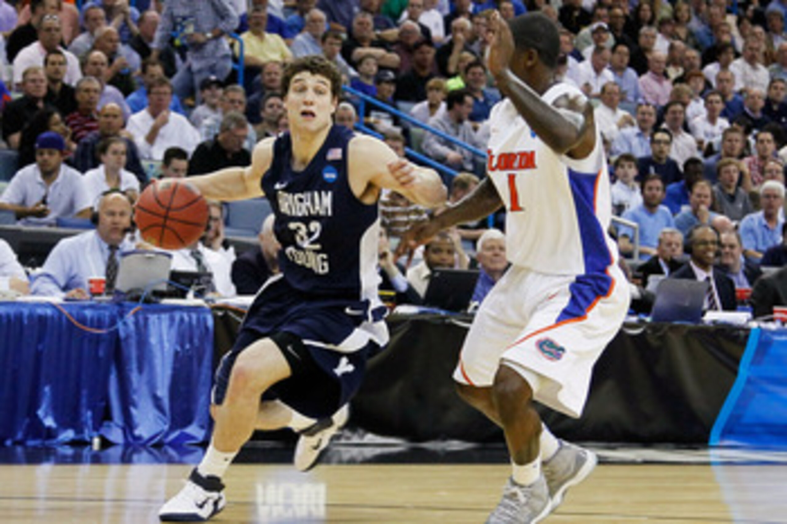 NEW ORLEANS, LA - MARCH 24:  Jimmer Fredette #32 of the Brigham Young Cougars drives past Kenny Boynton #1 of the Florida Gators during the Southeast regional of the 2011 NCAA men's basketball tournament at New Orleans Arena on March 24, 2011 in New Orlea