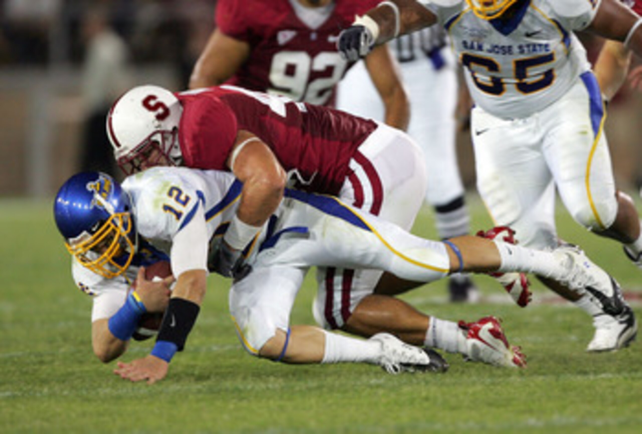 PALO ALTO, CA - SEPTEMBER 19:  Jordan La Secia #12 of the San Jose State Spartans is sacked by Will Powers #42 of the Stanford Cardinal at Stanford Stadium on September 19, 2009 in Palo Alto, California.  (Photo by Ezra Shaw/Getty Images)