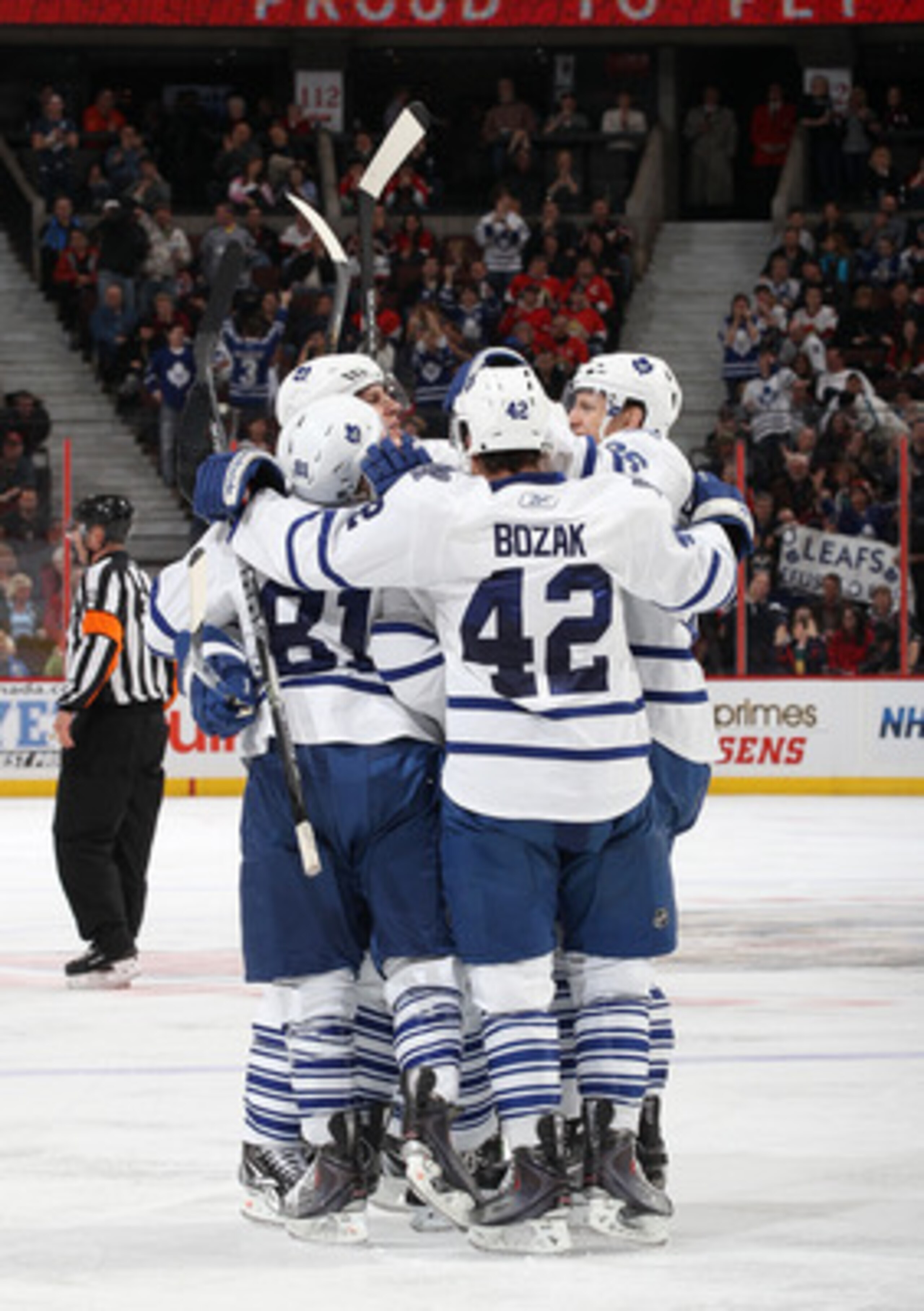 OTTAWA, CANADA - APRIL 2: Tyler Bozak #42 of the Toronto Maple Leafs celebrates his third period goal with team mates Phil Kessel #81Carl Gunnarsson #36 against the Ottawa Senators at Scotiabank Place on April 2, 2011 in Ottawa, Ontario, Canada.  (Photo b