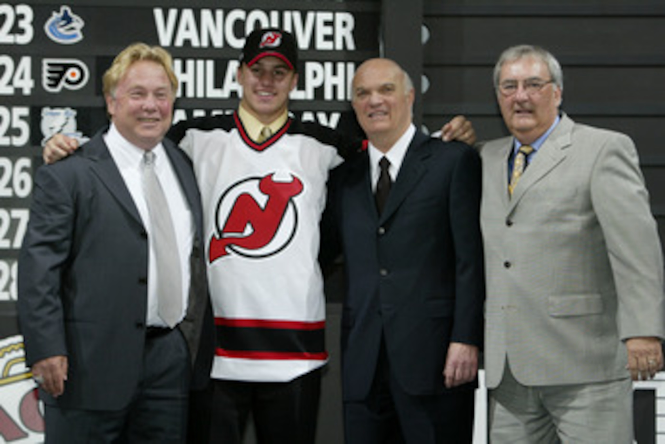 NASHVILLE, TN - JUNE 21:  (L to R) David Conte, first round draft pick (#17 overall) Zach Parise, Lou Lamoriello and Claude Carrier of the New Jersey Devils pose for a portrait on stage during the 2003 NHL Entry Draft at the Gaylord Entertainment Center o
