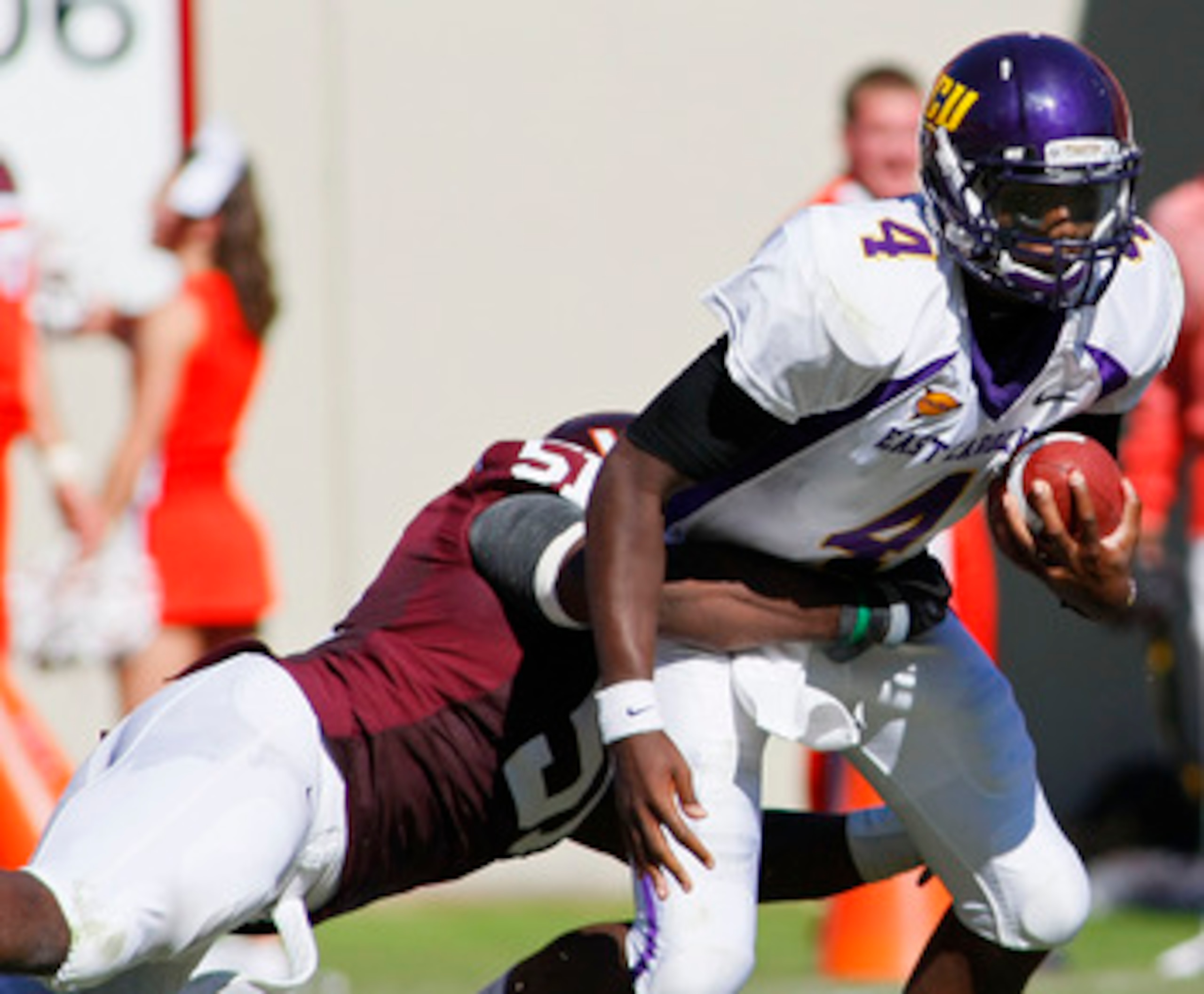 BLACKSBURG, VA - SEPTEMBER 18: Quarterback Dominique Davis #4 of the East Carolina Pirates is sacked by linebacker Bruce Taylor #51 of the Virginia Tech Hokies at Lane Stadium on September 18, 2010 in Blacksburg, Virginia.  (Photo by Geoff Burke/Getty Ima
