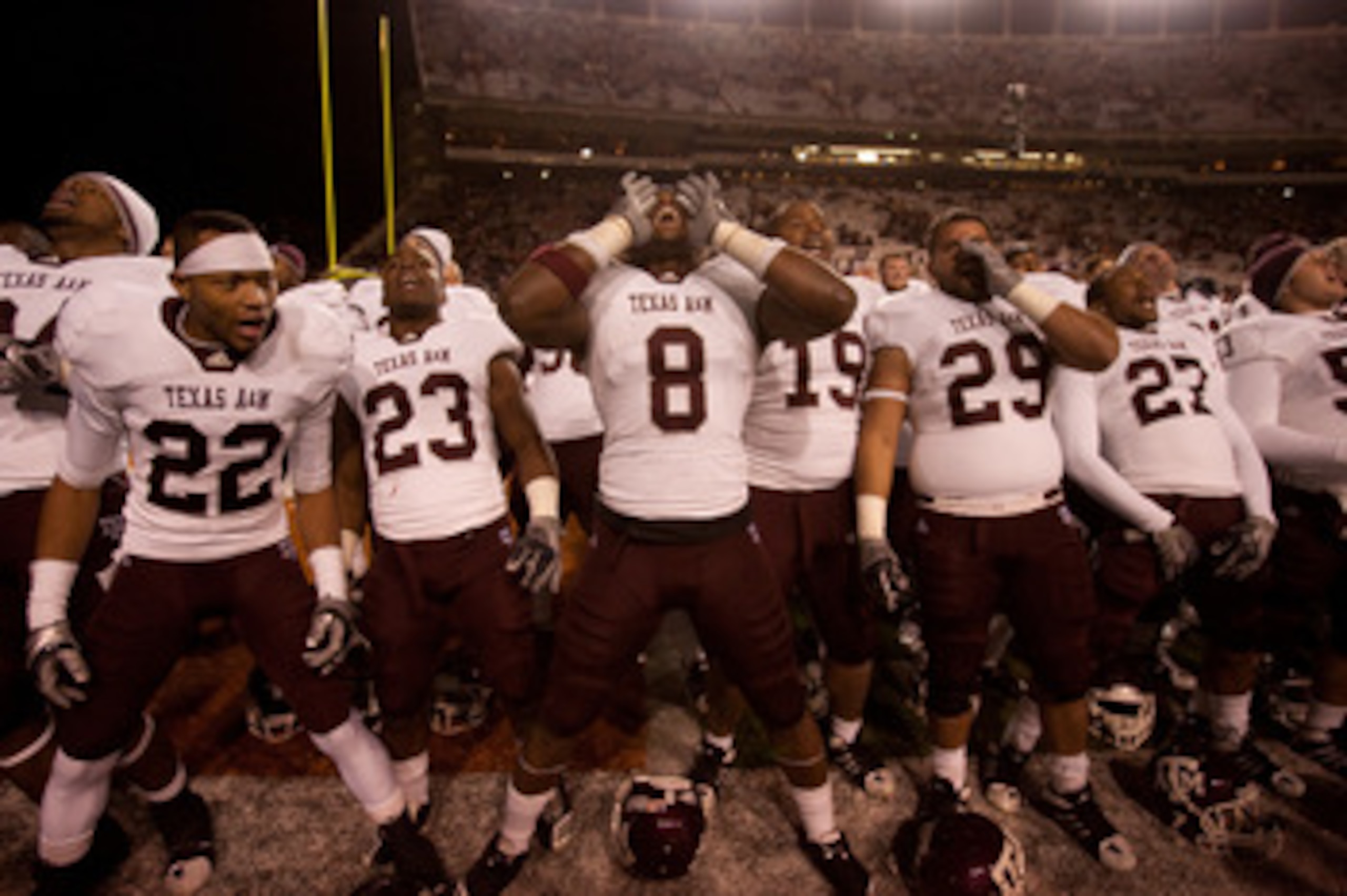 AUSTIN, TX - NOVEMBER 25:  Texas A&M players (L-R) Dustin Harris #22, Ben Malena #23, Jeff Fuller #8, Michael Lamothe #19, Blane Cheatham #29, and C.J. Jones #27 celebrate Texas A&M's 24-17 win over the University of Texas at Darrell K. Royal-Texas Memori
