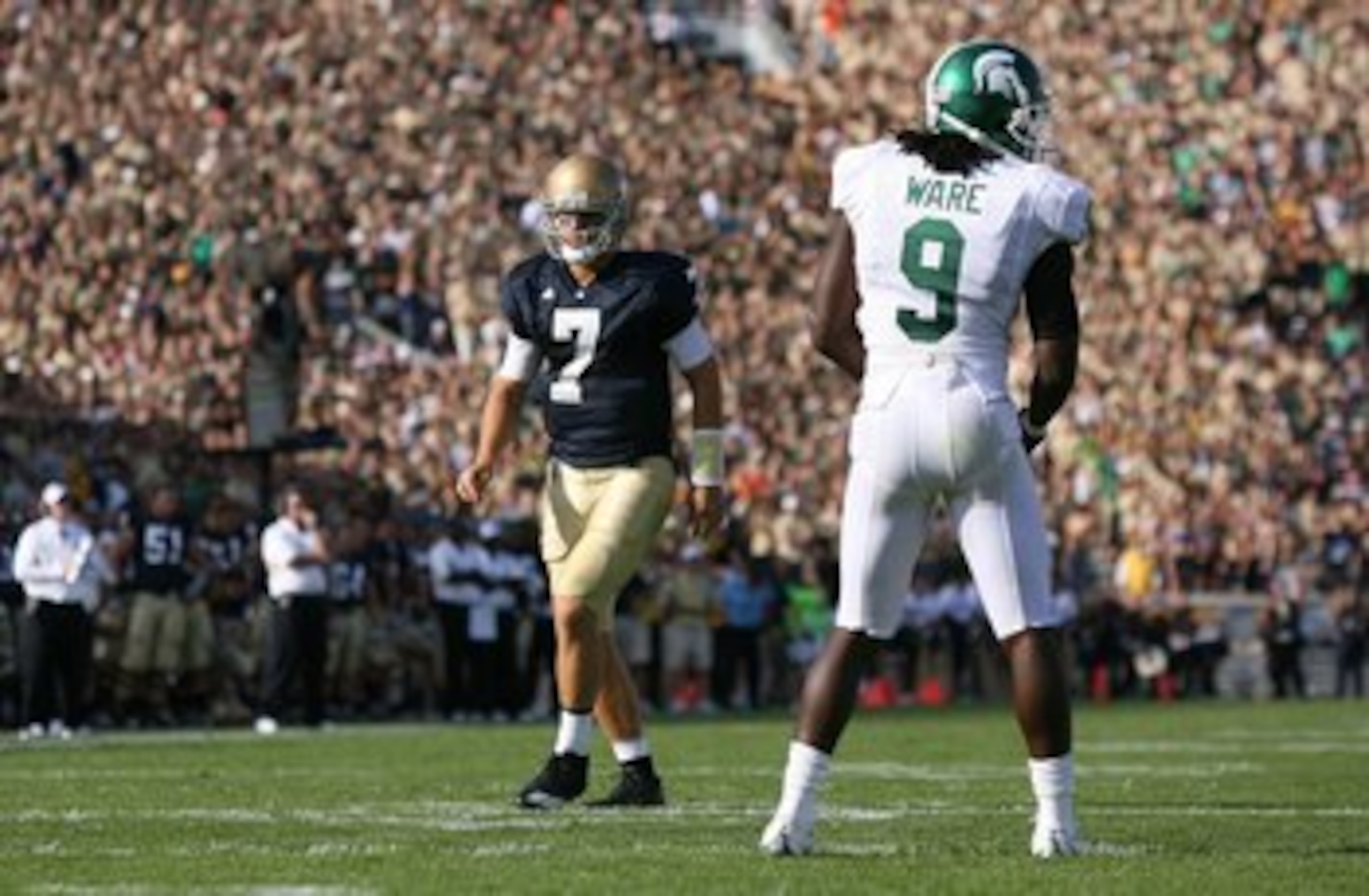 SOUTH BEND, IN - SEPTEMBER 19: Quarterback Jimmy Clausen #7 of the Notre Dame Fighting Irish runs a play at wide receiver in the 'wildcat' formation against Jeremy Ware #9 of the Michigan State Spartans on September 19, 2009 at Notre Dame Stadium in South