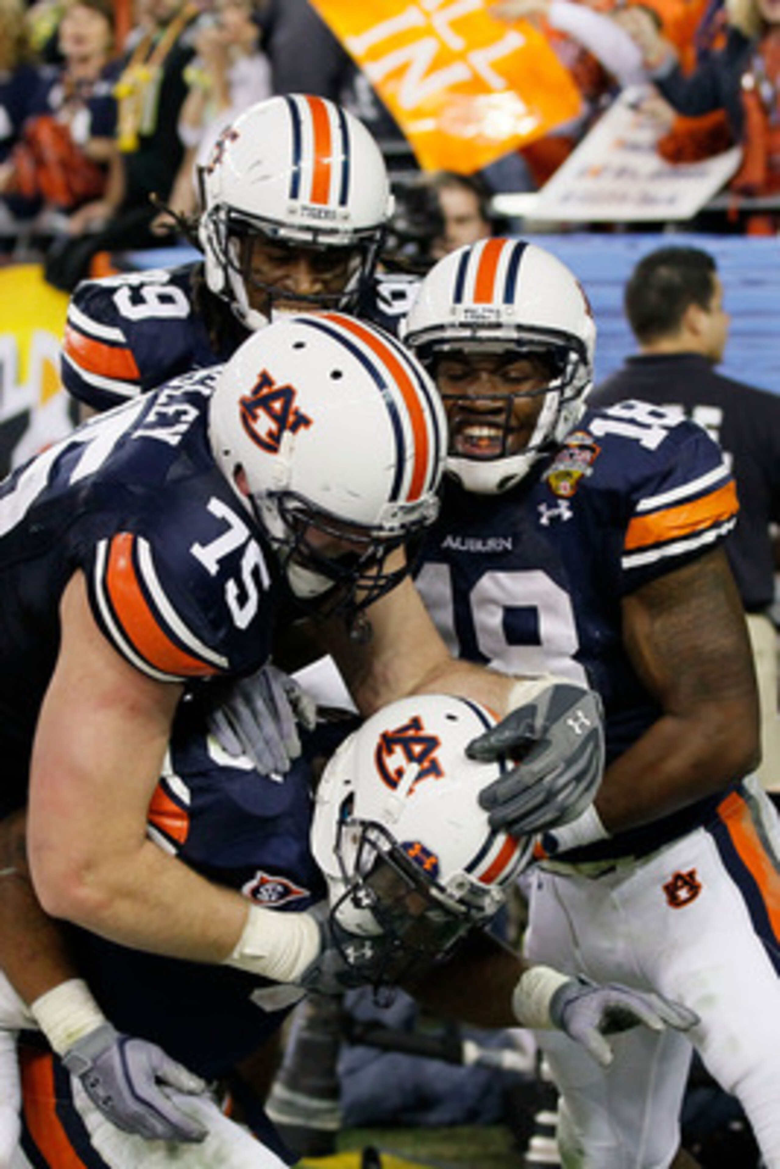 GLENDALE, AZ - JANUARY 10:  Michael Dyer #5 of the Auburn Tigers celebrates with teammates Brandon Mosley #75 and Kodi Burns #18 after he ran the ball for 16-yards and is called down at the one-yardline with 10 seconds remaining in the fourth quarter agai