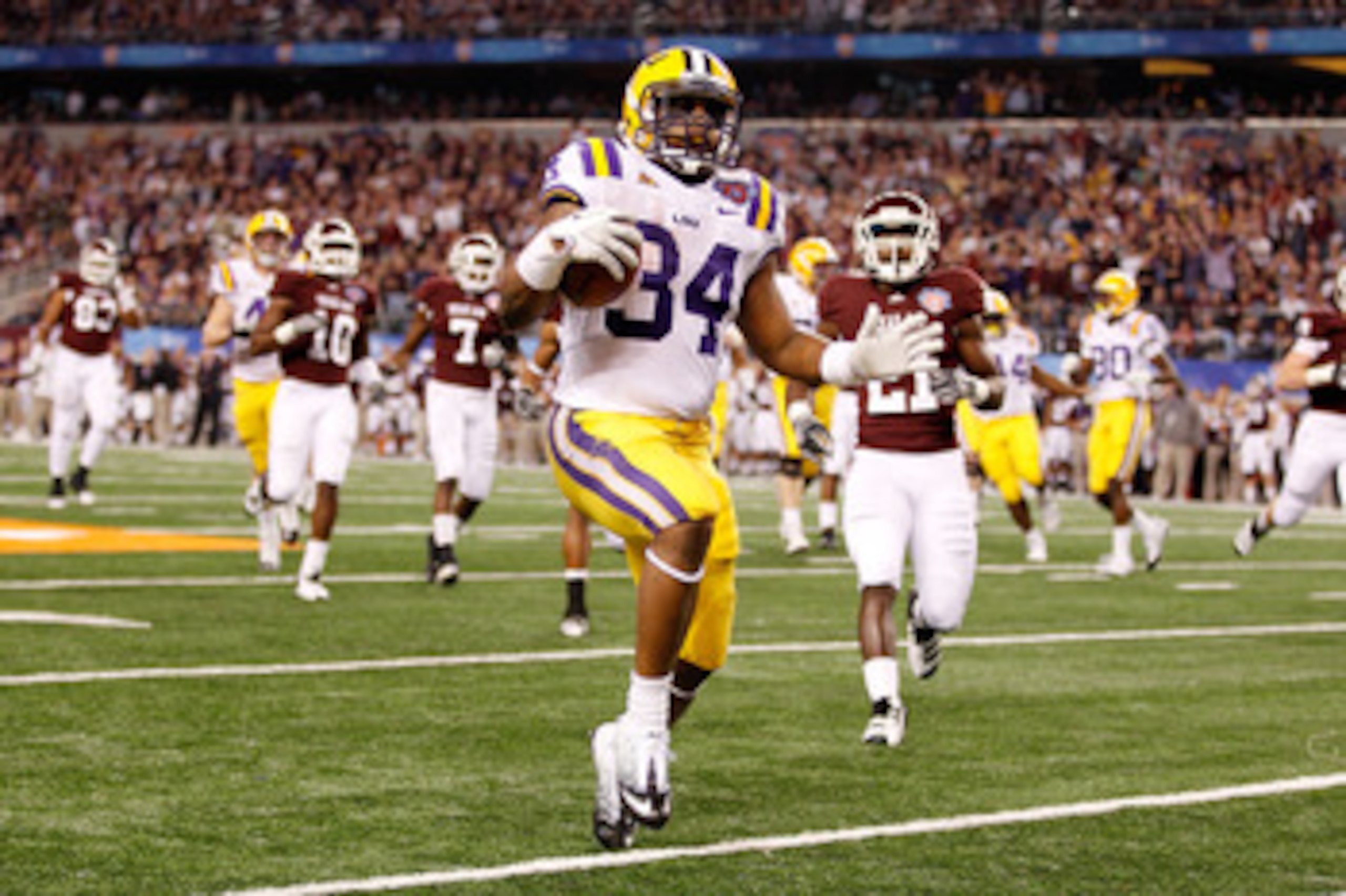 ARLINGTON, TX - JANUARY 07:  Stevan Ridley #34 of the Louisiana State University Tigers runs in for a touchdown during the game against the Texas A&M Aggies during the AT&T Cotton Bowl at Cowboys Stadium on January 7, 2011 in Arlington, Texas.  (Photo by