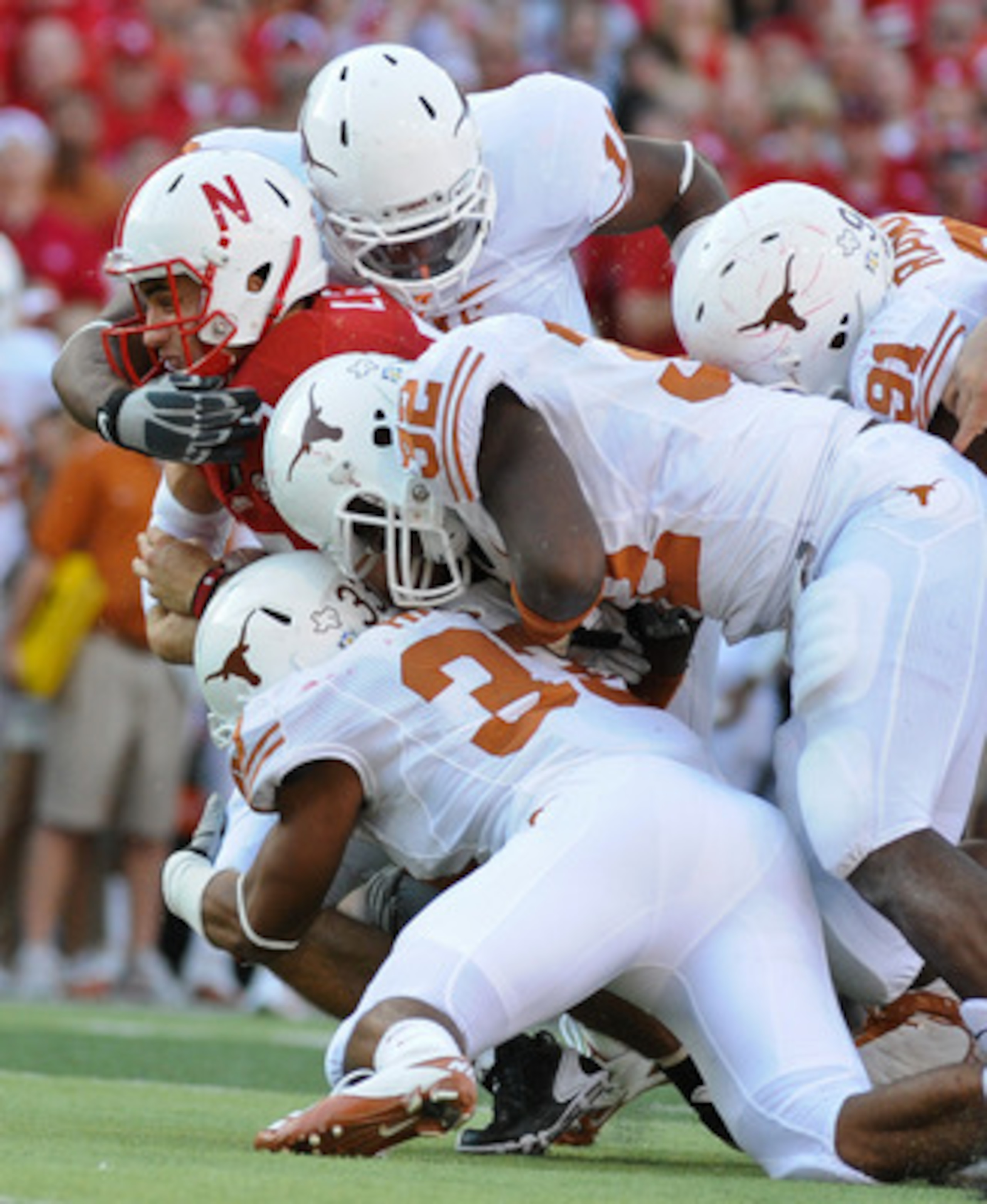 LINCOLN, NE - OCTOBER 16: Quarterback Zac Lee #5 of the Nebraska Cornhuskers is tackled by the Texas longhorn defense during second half action of their game at Memorial Stadium on October 16, 2010 in Lincoln, Nebraska. Texas Defeated Nebraska 20-13. (Pho