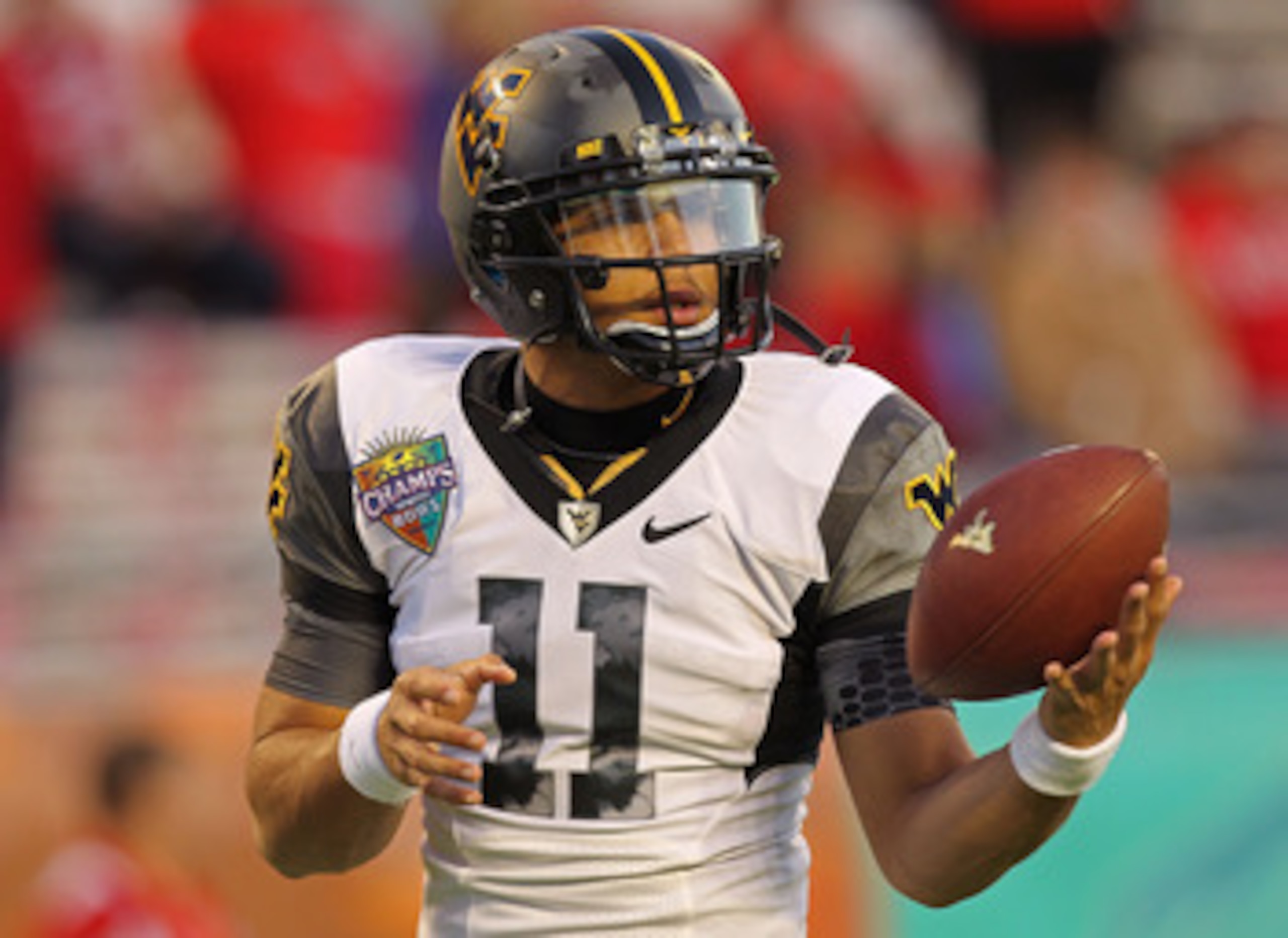 ORLANDO, FL - DECEMBER 28:  Barry Brunetti #11 of the West Virginia Mountineers warms up during the Champs Sports Bowl against the North Carolina State Wolfpack at Florida Citrus Bowl Stadium on December 28, 2010 in Orlando, Florida.  (Photo by Mike Ehrma