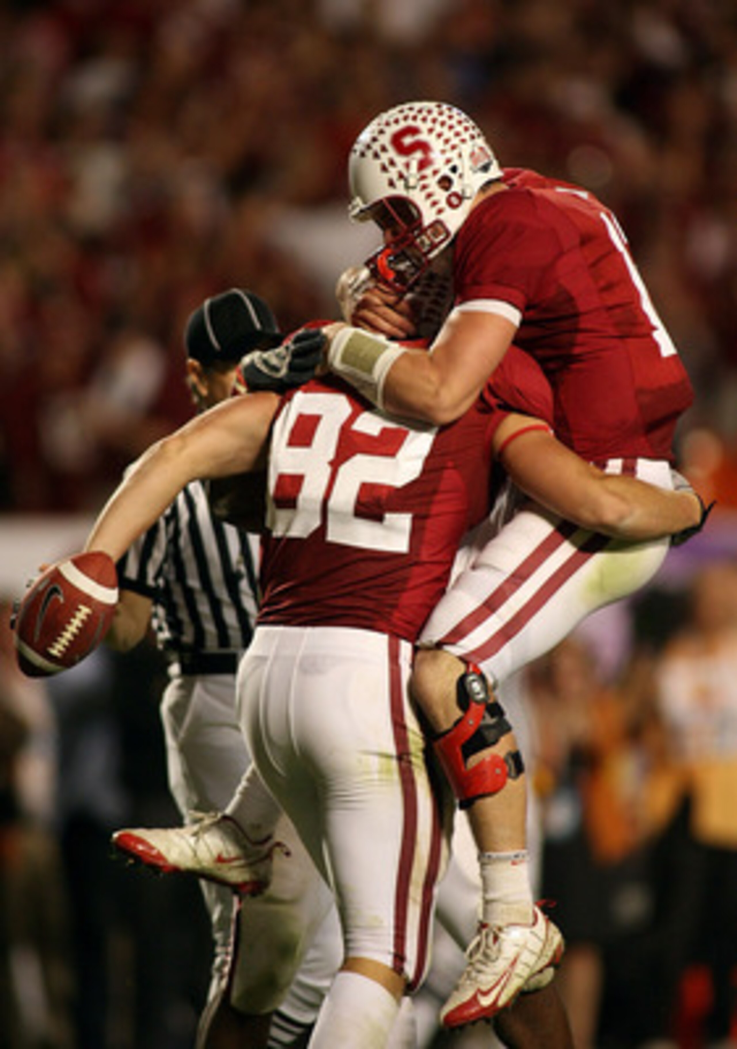 MIAMI, FL - JANUARY 03: Quarterback Andrew Luck #12 and Coby Fleener #82 of the Stanford Cardinal celebrate after Luck threw Fleener a 41-yard touchdown pass in the third quarterback against the Virginia Tech Hokies during the 2011 Discover Orange Bowl at