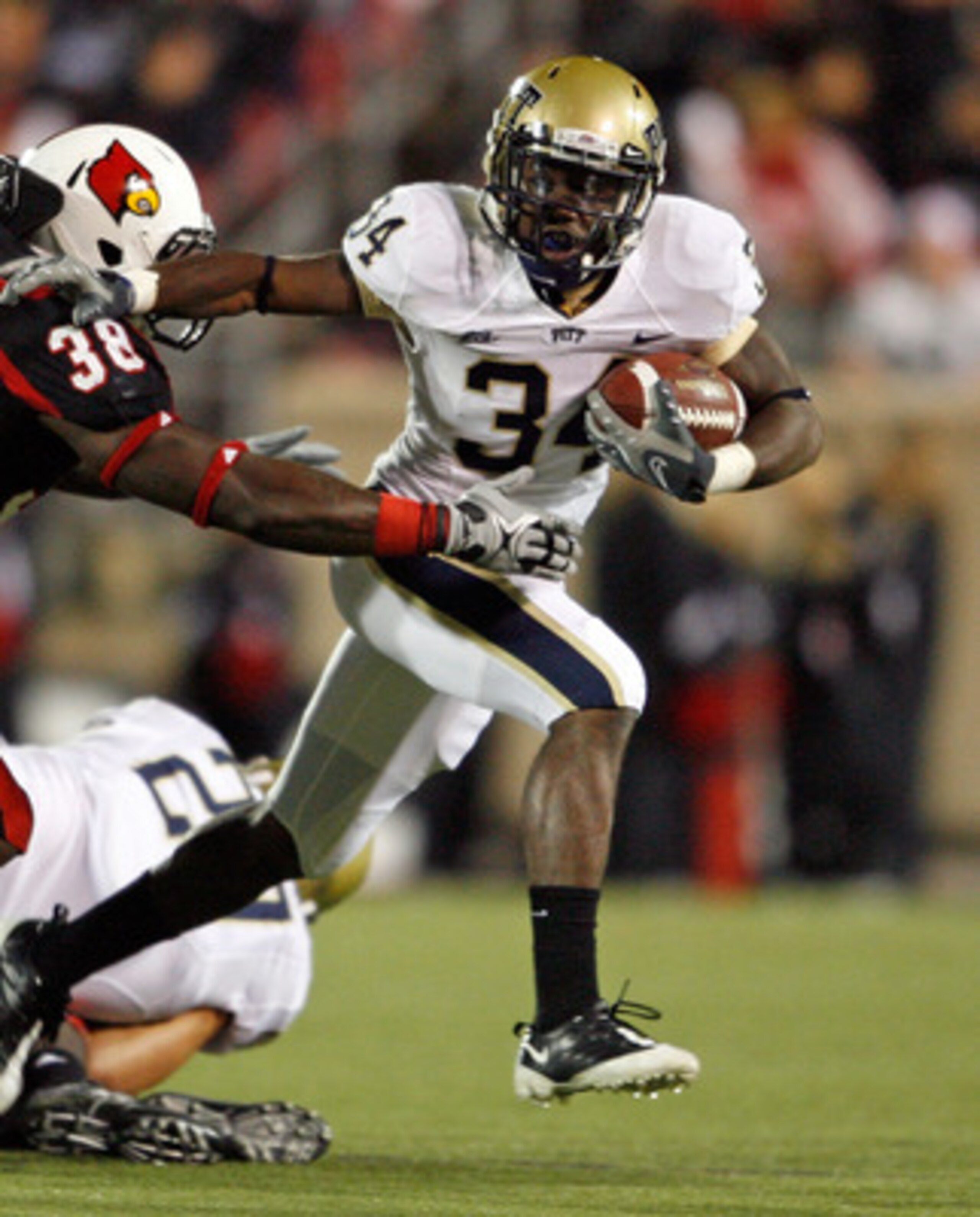 LOUISVILLE, KY - OCTOBER 02:  Ray Graham #34 of the Pittsburgh Panthers runs with the ball  while defended by Jon Dempsey #38 of the Louisville Cardinals during the Big East Conference game at Papa John's Cardinal Stadium on October 2, 2009 in Louisville,
