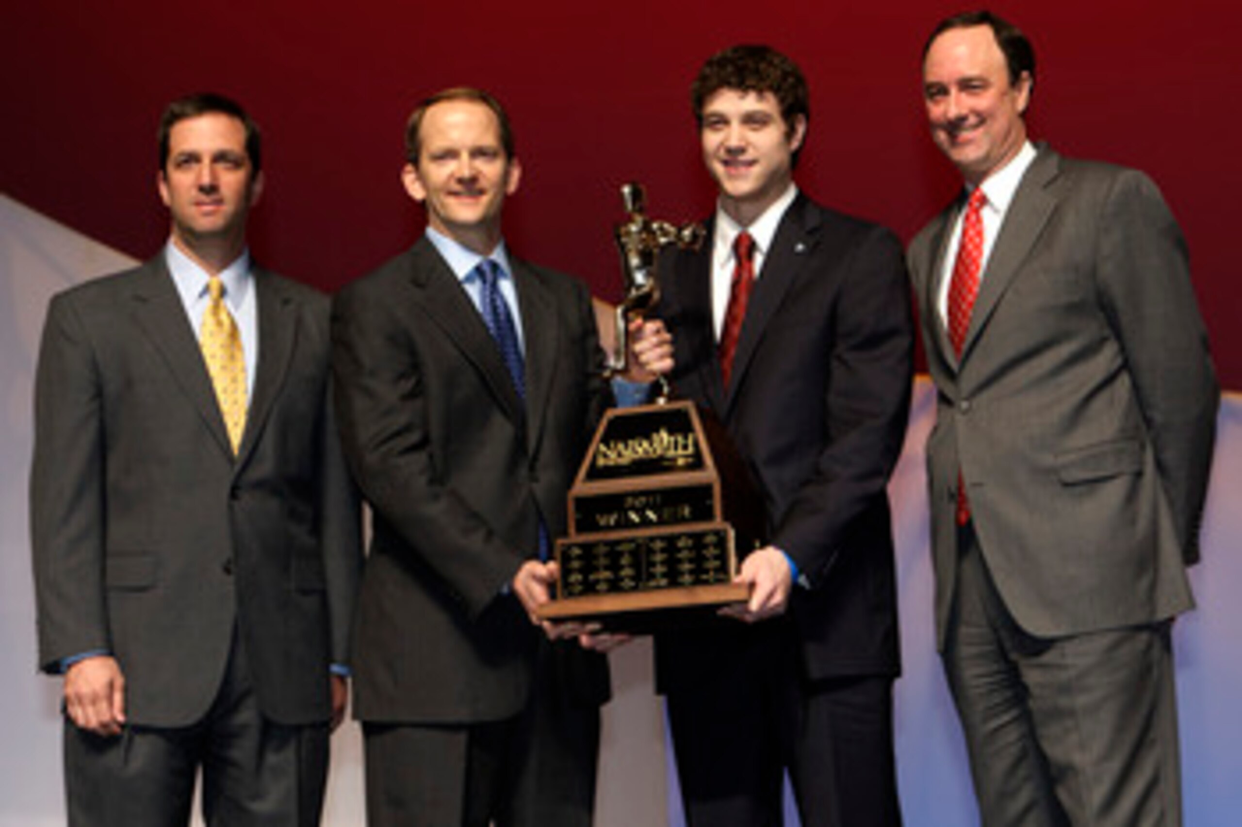 HOUSTON - APRIL 03: Jimmer Fredette of BYU receives the 2011 Naismith Trophy Presented by AT&T from David Christopher of AT&T during the NABC Guardians of the Game Awards Program on April 3, 2011 in Houston, Texas. Joining them on stage are Eric Oberman HOUSTON - APRIL 03: Jimmer Fredette of BYU receives the 2011 Naismith Trophy Presented by AT&T from David Christopher of AT&T during the NABC Guardians of the Game Awards Program on April 3, 2011 in Houston, Texas. Joining them on stage are Eric Oberman