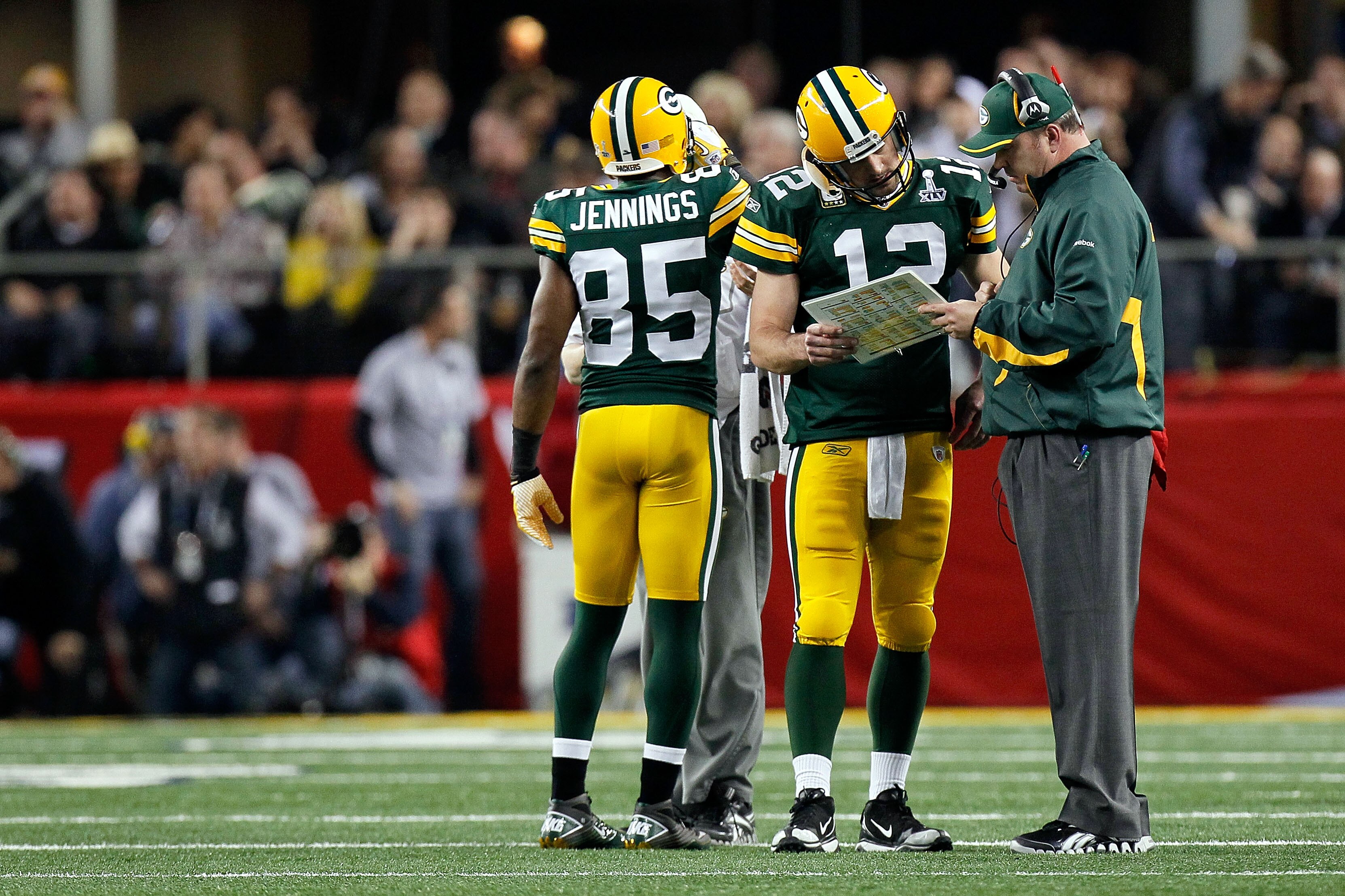 ARLINGTON, TX - FEBRUARY 06:  Aaron Rodgers #12 and head coach Mike McCarthy of the Green Bay Packers talk during a stop in play against the Pittsburgh Steelers during Super Bowl XLV at Cowboys Stadium on February 6, 2011 in Arlington, Texas.  (Photo by K