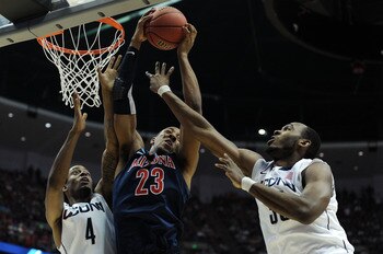 ANAHEIM, CA - MARCH 26:  Derrick Williams #23 of the Arizona Wildcats goes up for a rebound against Jamal Coombs-McDaniel #4 and Charles Okwandu #35 of the Connecticut Huskies during the west regional final of the 2011 NCAA men's basketball tournament at 