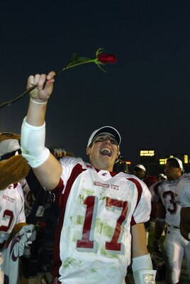 PASADENA, CA - DECEMBER 7:  Quarterback Jason Gesser #17 of the Washington University State Cougars celebrates by holding a rose in the air following the win over the University of California, Los Angeles Bruins at the Rose Bowl on December 7, 2002 in Pas