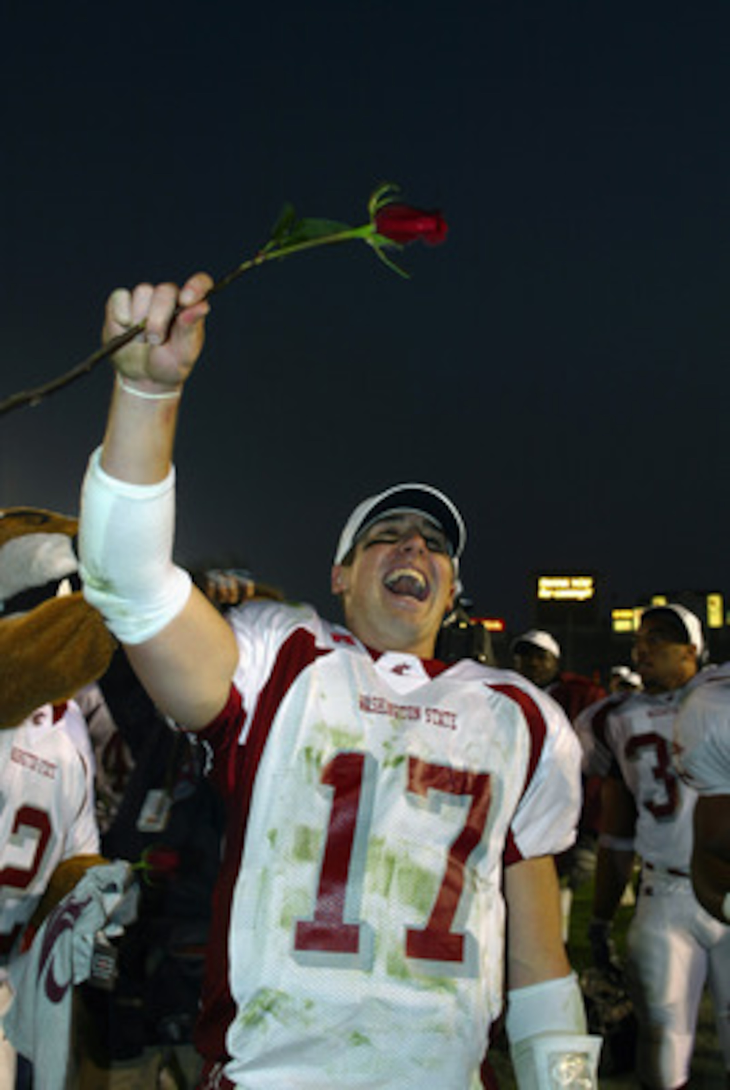 PASADENA, CA - DECEMBER 7:  Quarterback Jason Gesser #17 of the Washington University State Cougars celebrates by holding a rose in the air following the win over the University of California, Los Angeles Bruins at the Rose Bowl on December 7, 2002 in Pas