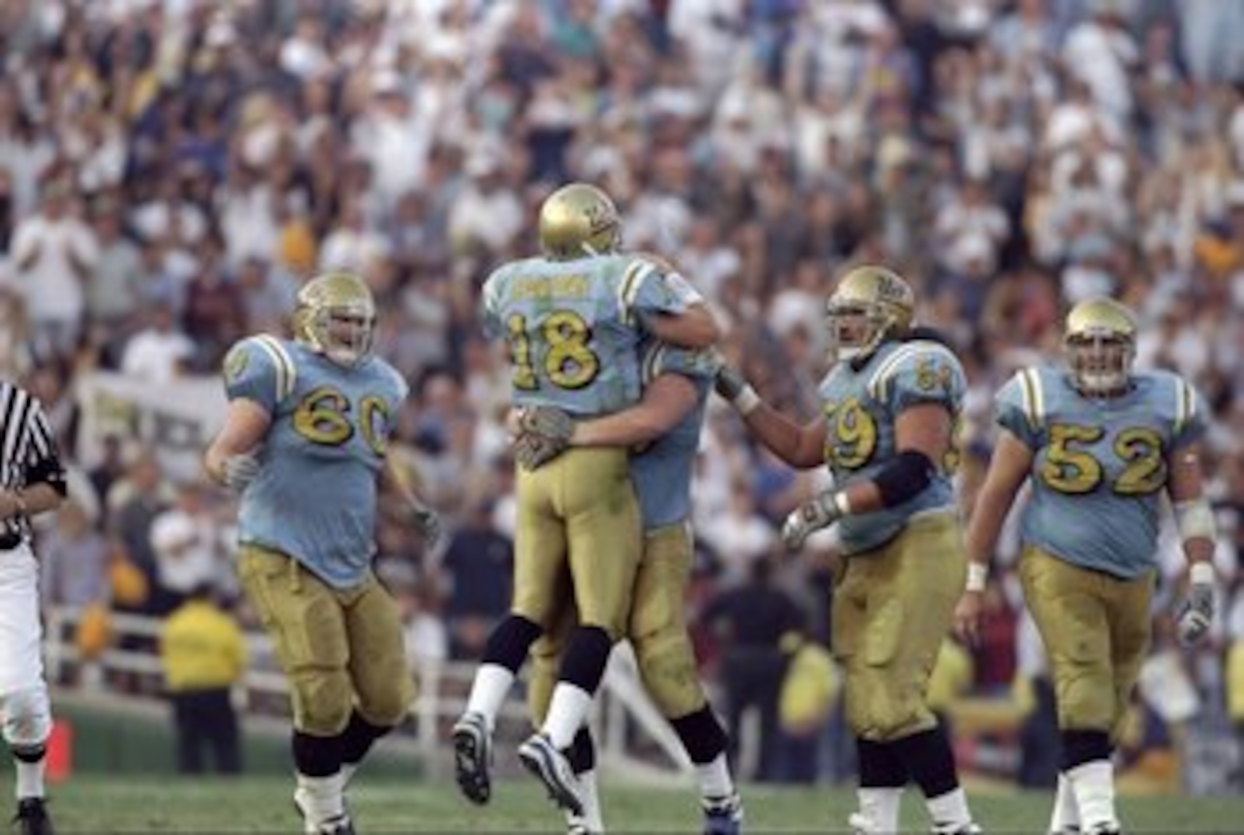 21 Nov 1998:  Quarterback Cade McNown #18 and offensive guard Andy Meyers #78 of the UCLA Bruins ce:ebrate during the game against the USC Trojans at the Rose Bowl in Pasadena, California. The Bruins defeated the Trojans 34-17. Mandatory Credit: David Tay
