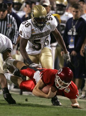 TEMPE, AZ - JANUARY 1:  Quarterback Alex Smith #11 of Utah is tripped up by Joe Clermond #58 of Pittsburgh in the first quarter of the Tostito's Fiesta Bowl at the Sun Devil Stadium on January 1, 2005 in Tempe, Arizona. (Photo by Jeff Gross/Getty Images).