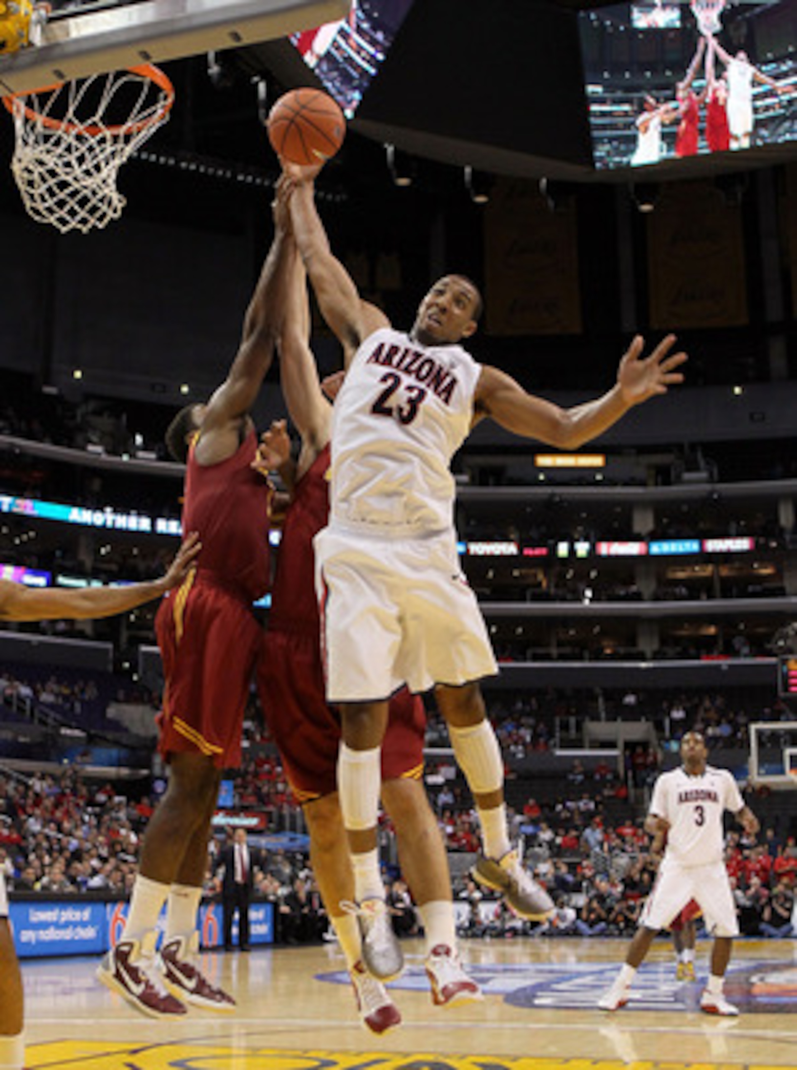 LOS ANGELES, CA - MARCH 11:  Derrick Williams #23 of the Arizona Wildcats goes up for a rebound in front of Alex Stepheson #1 of the USC Trojans in the second half in the semifinals of the 2011 Pacific Life Pac-10 Men's Basketball Tournament at Staples Ce