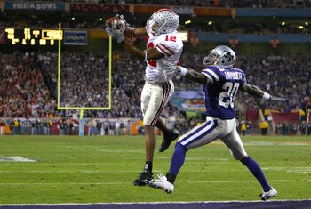 TEMPE, AZ - JANUARY 2:  Michael Jenkins #12 of the Ohio State Buckeyes catches a touchdown pass over the defense of Louis Lavender #20 of the Kansas State Wildcats during the second half of the Fiesta Bowl on January 2, 2004 at the Sun Devil Stadium in Te